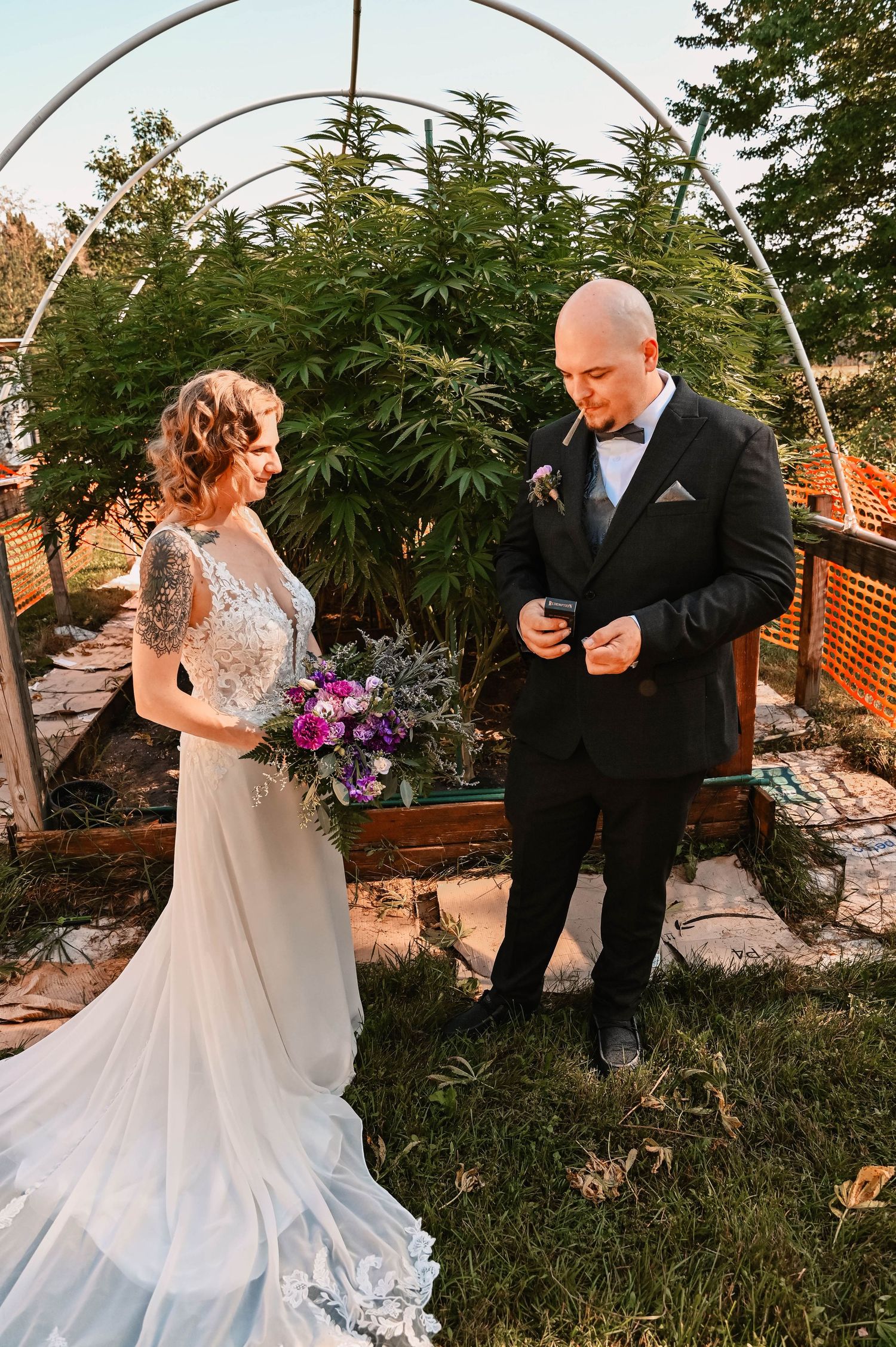 Wedding ceremony scene with couple under white arch surrounded by lush garden.
