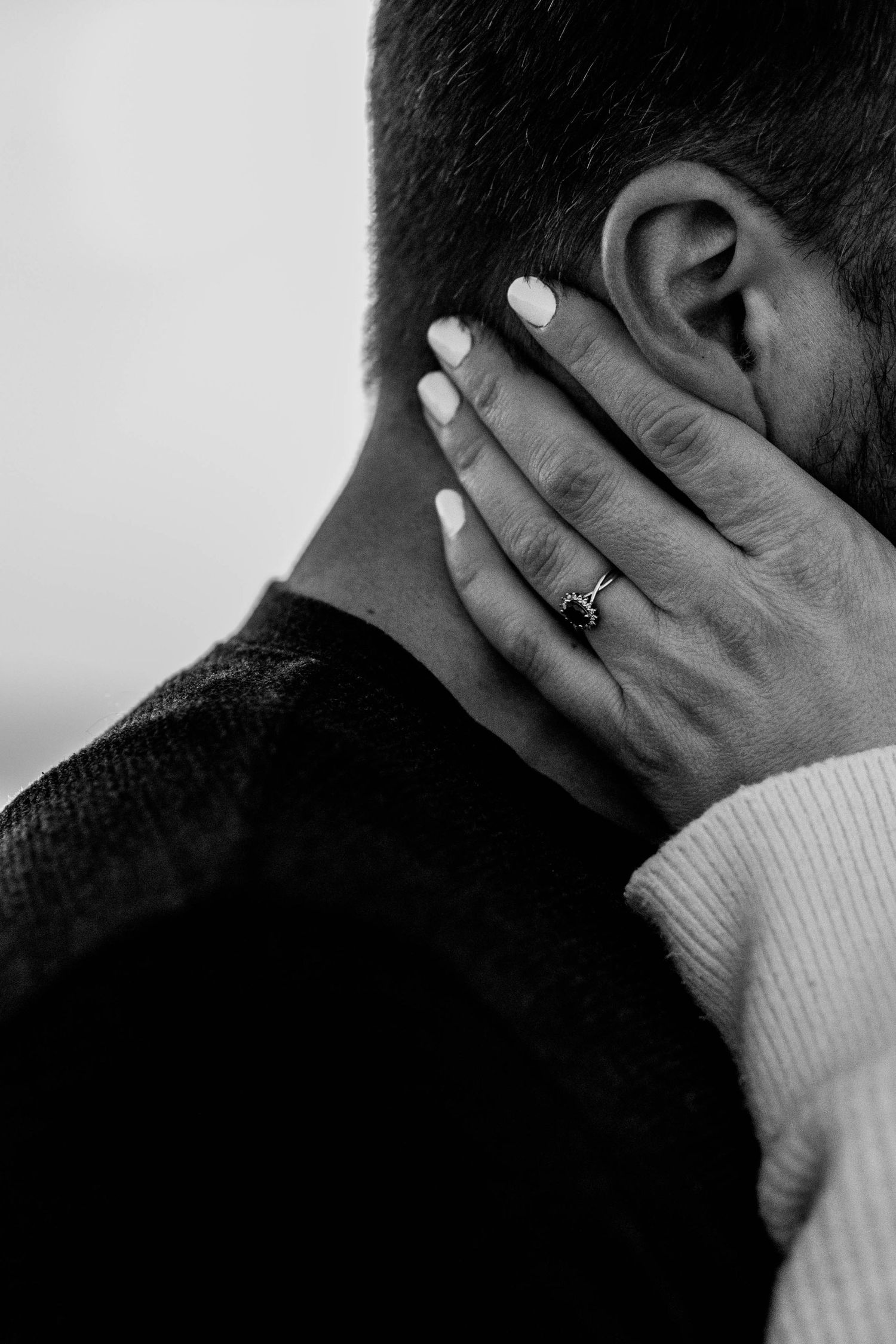 Black and white close-up series showing hands with engagement ring in intimate moments.