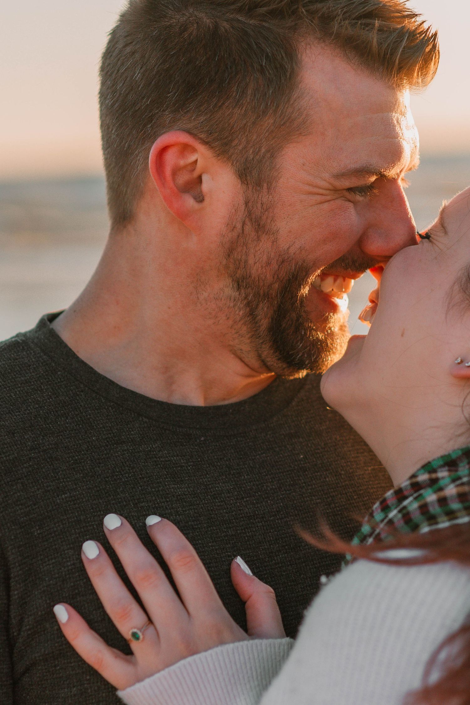 Close-up of intimate moment between couple during sunset.
