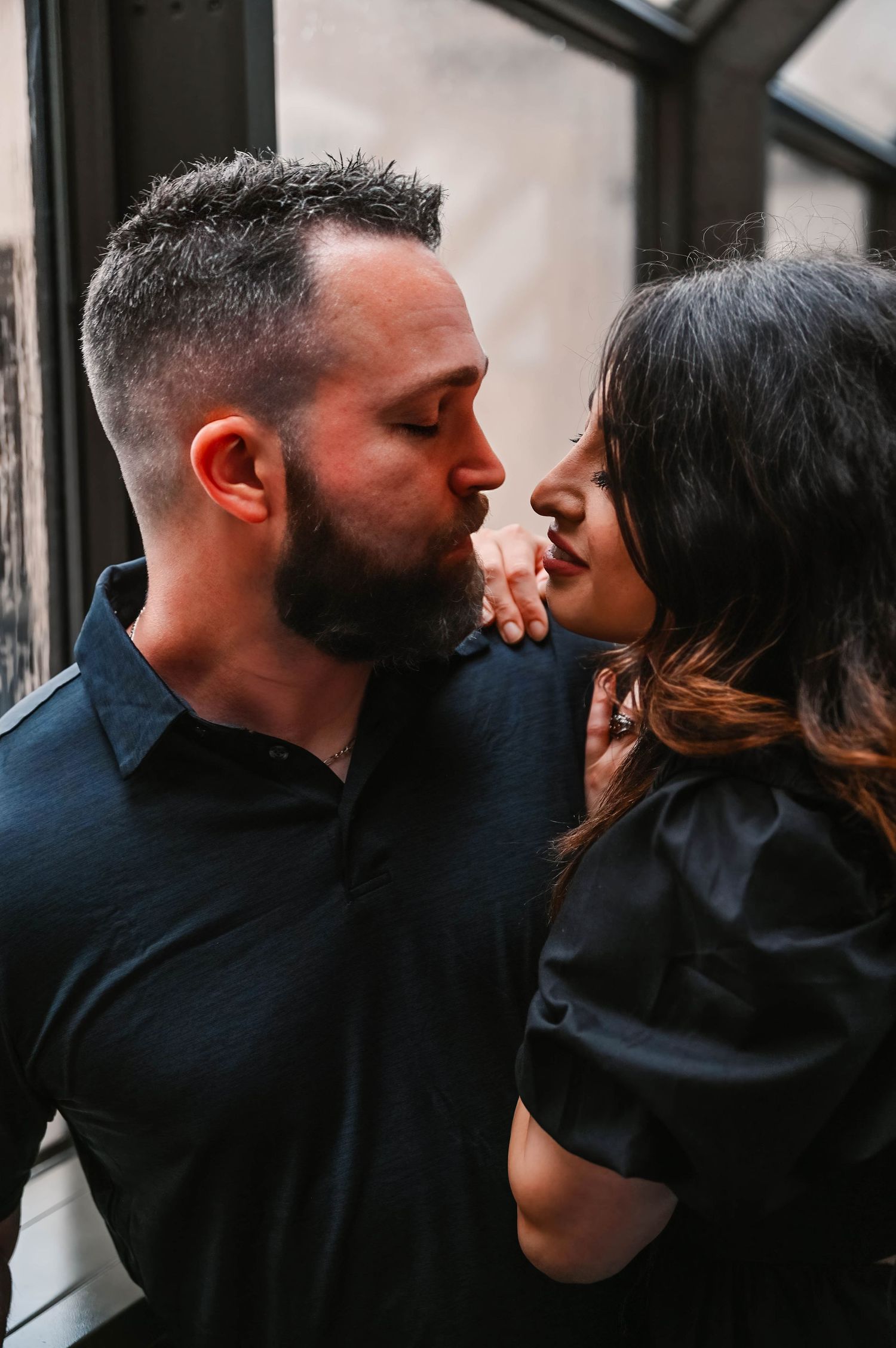 Tender embrace sequence showing couple in matching black attire.