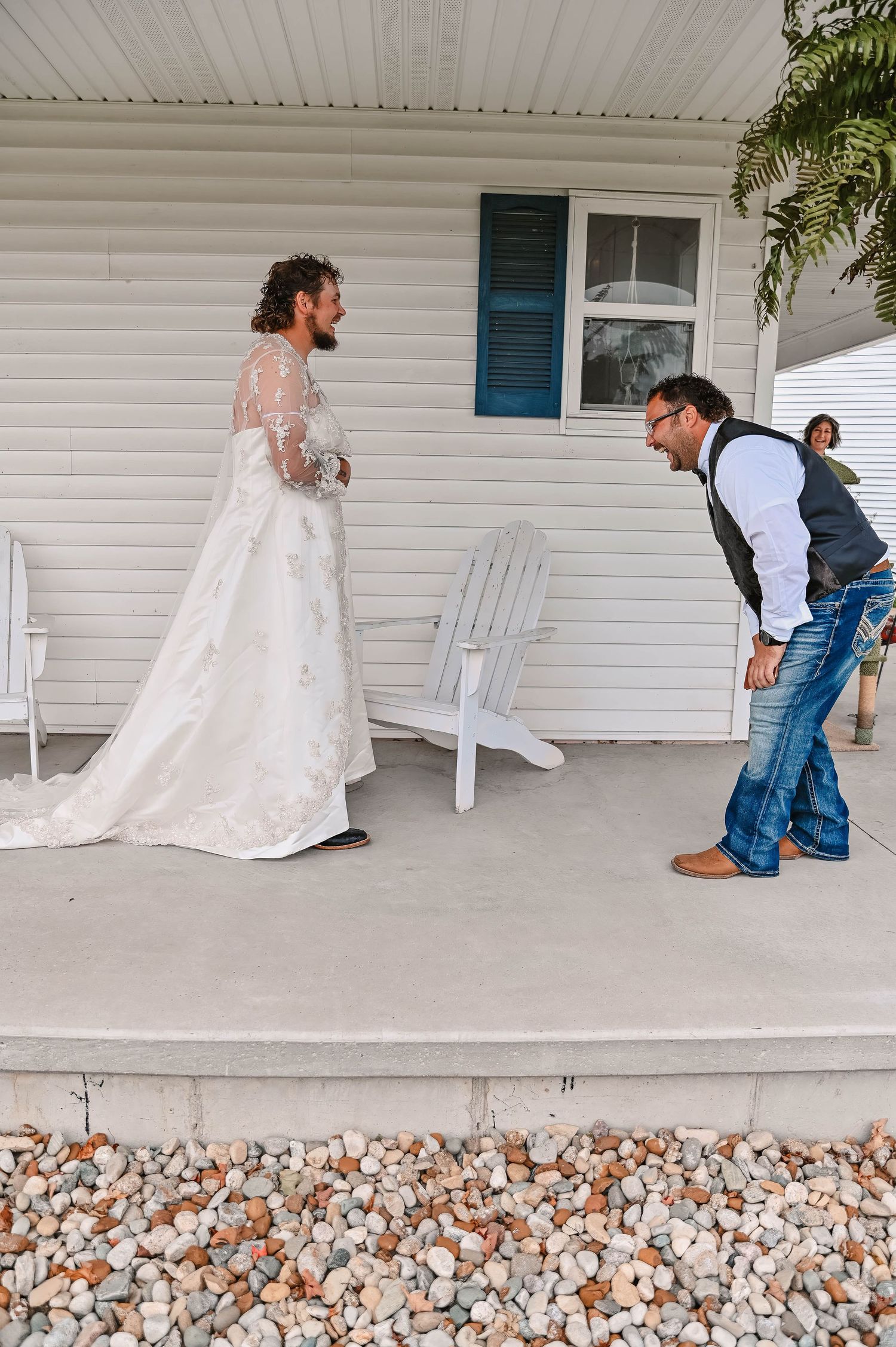 A wedding scene on a white porch with a lace dress and casual denim attire creating a rustic country vibe.