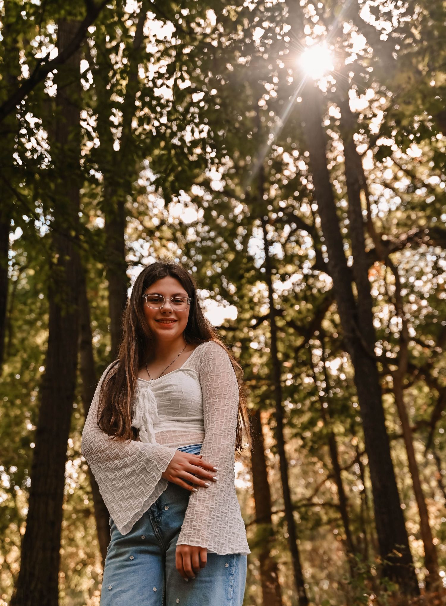 A candid autumn photoshoot in a sunlit forest featuring casual outfits and warm lighting.