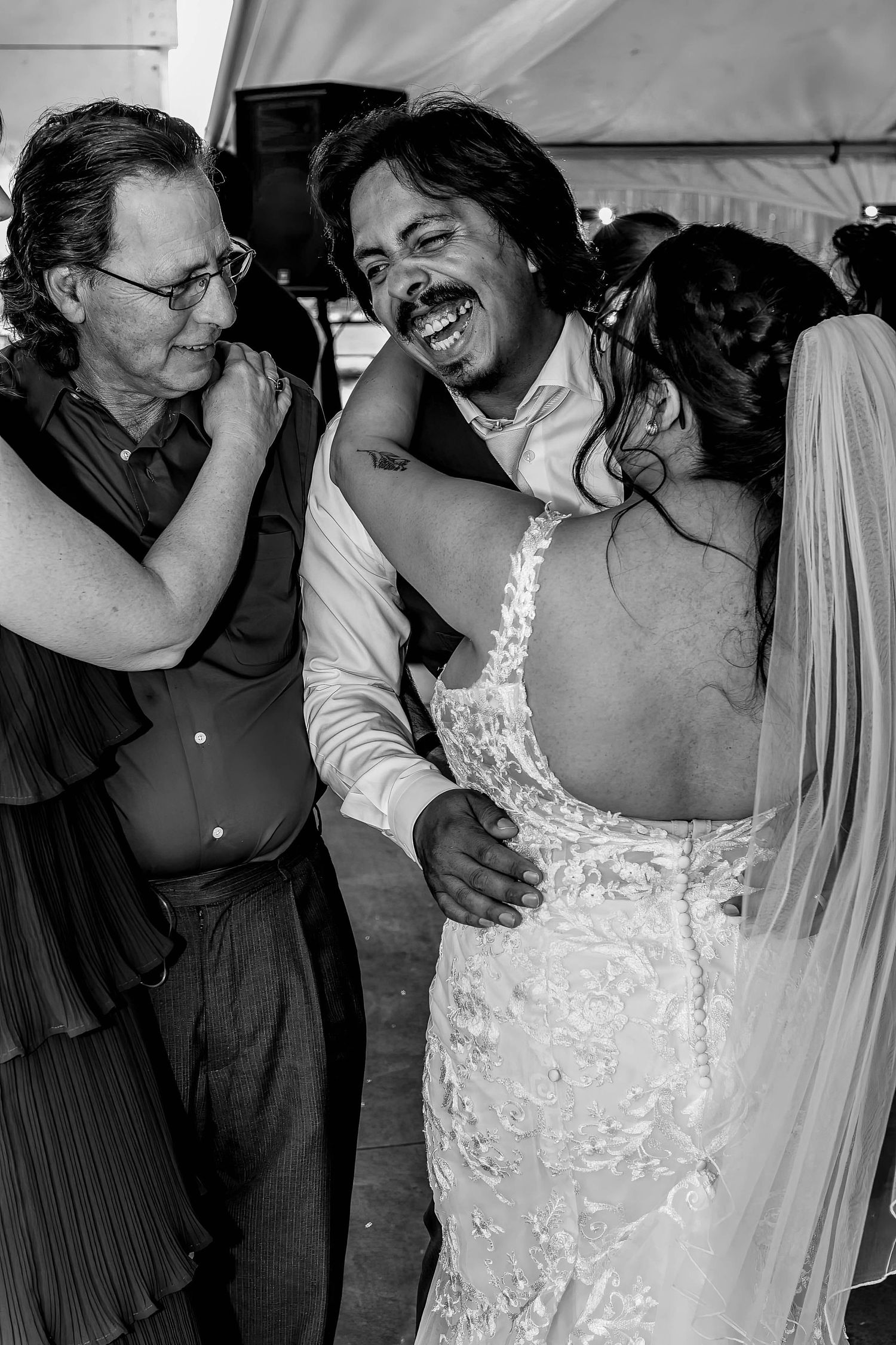 A series of romantic wedding photos showing intimate moments between the newlyweds in black and white.