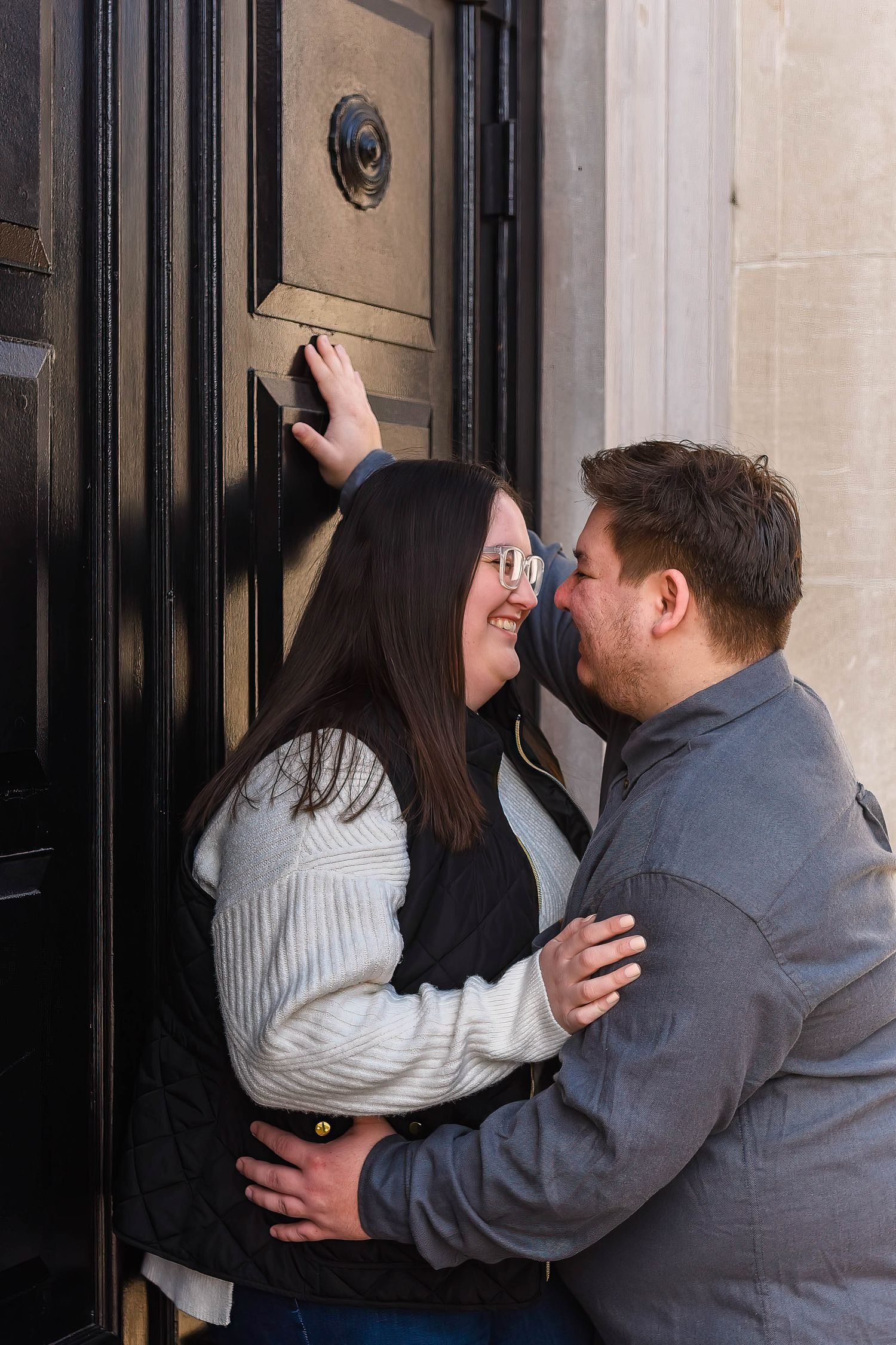 A couple sharing playful kisses against a dark doorway in a sequence of photos.