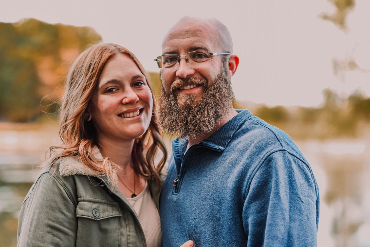 Couple sharing intimate moments during an outdoor photo session at sunset.