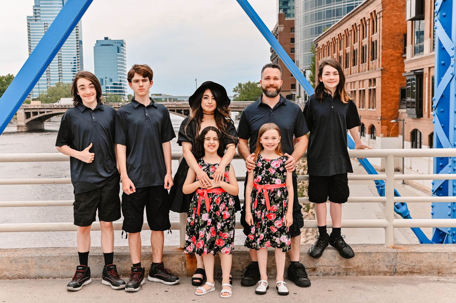 Group photo sequence on urban steps with blue architectural elements.
