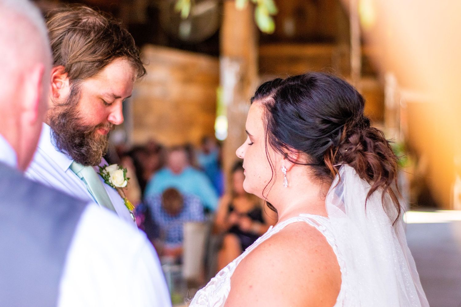 Wedding celebration with joyful dancing and embracing in an indoor venue.
