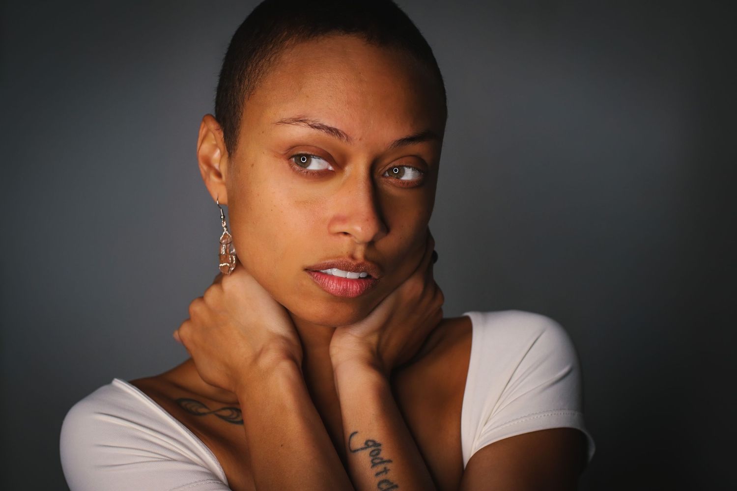 Black and white portrait series showing artistic poses against a dark background.