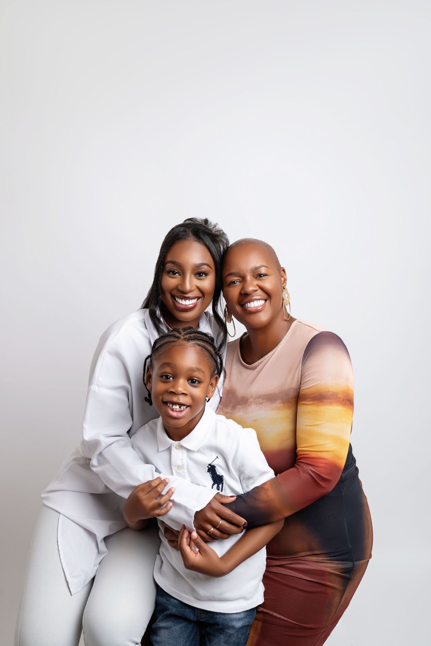 Joyful family portrait against white background showing genuine smiles.
