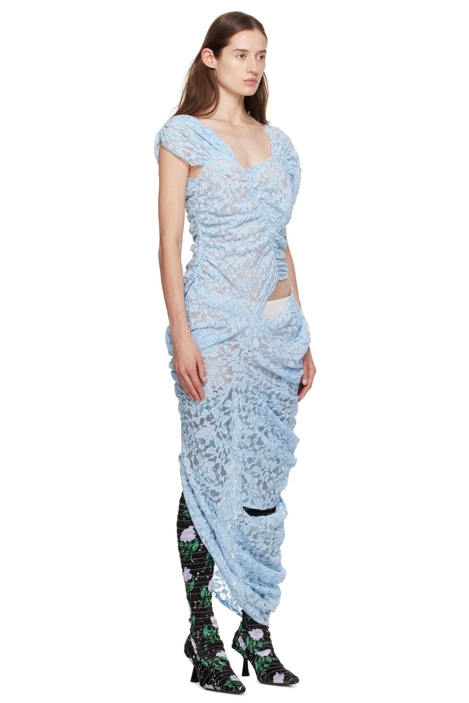 Model Ruby Evers wears a long blue lace gown and floral boots by designer Yuhan Wang.