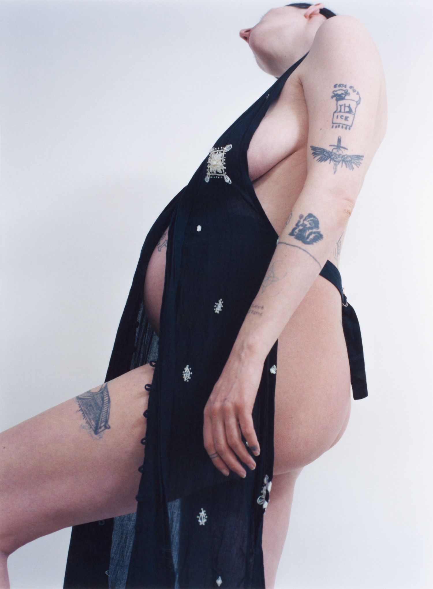 A pregnant model takes a step while wearing a dress by Limi Feu from HONNÊTE Boutique.