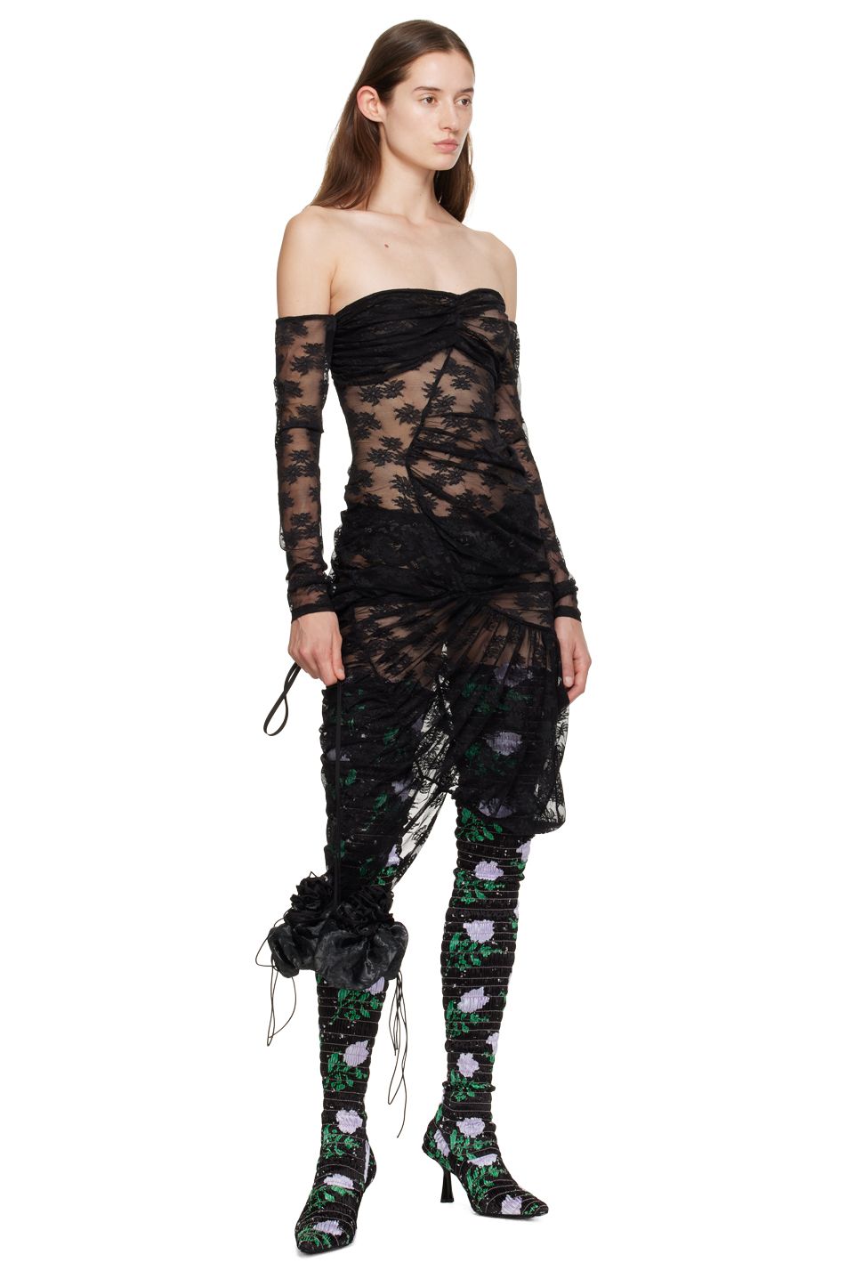 Model Ruby Evers wears a sheer black lace gown, handbag, and floral boots by designer Yuhan Wang.