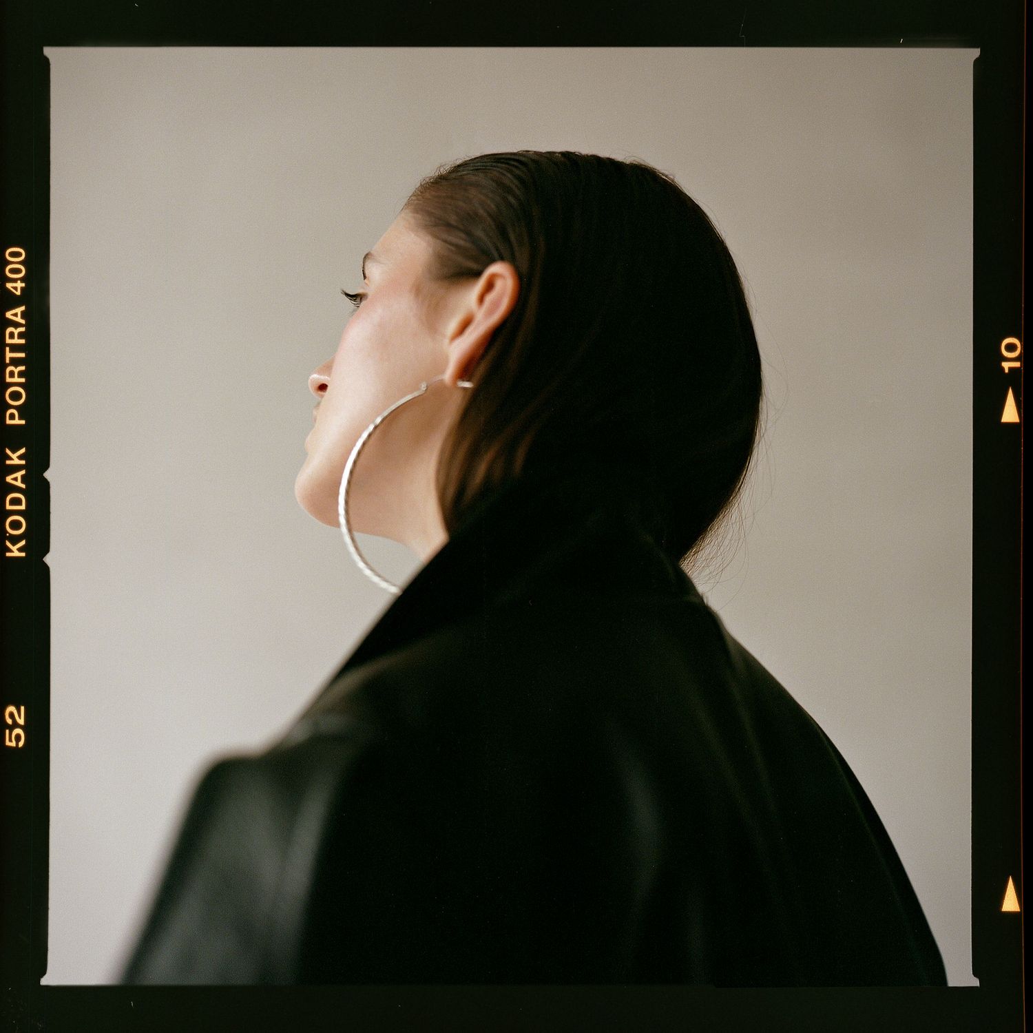 A 120mm colour film portrait with rebate edges of the back of a model's head.