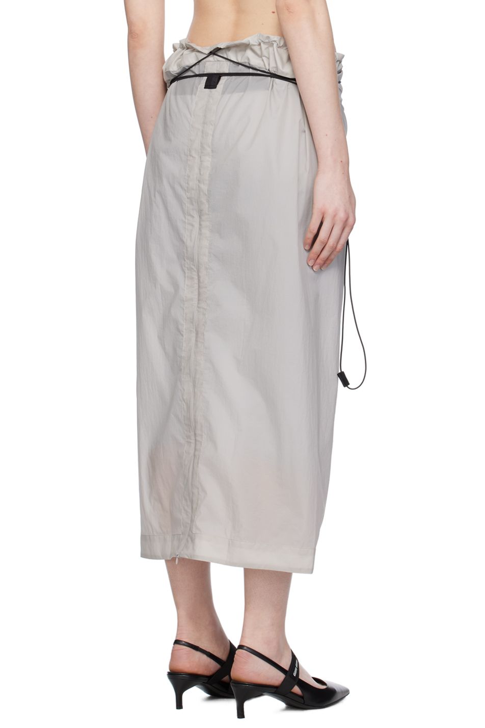 The back view of a grey nylon skirt by Johanna Parv on model.