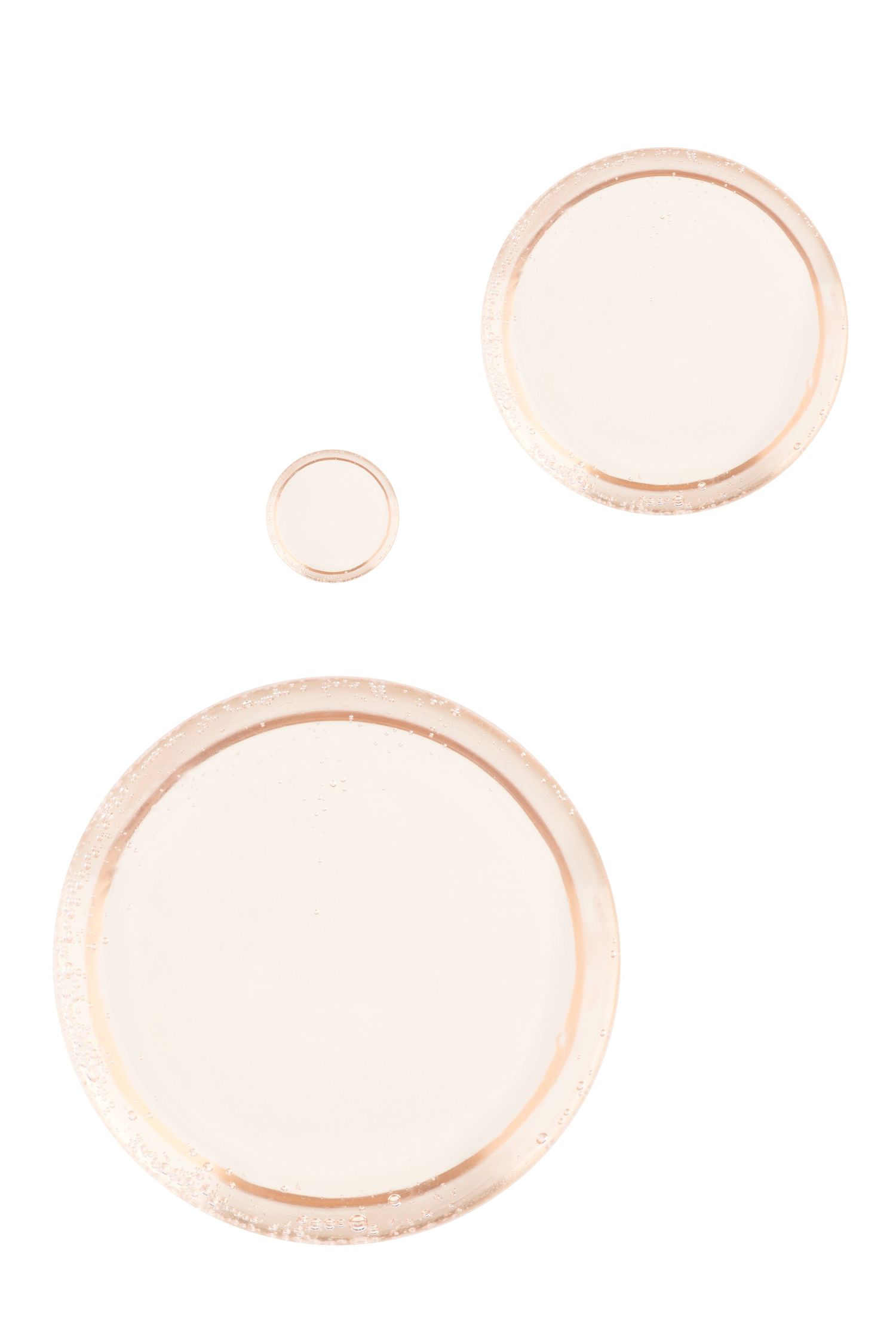 A product shot of translucent orange soap bubbles.