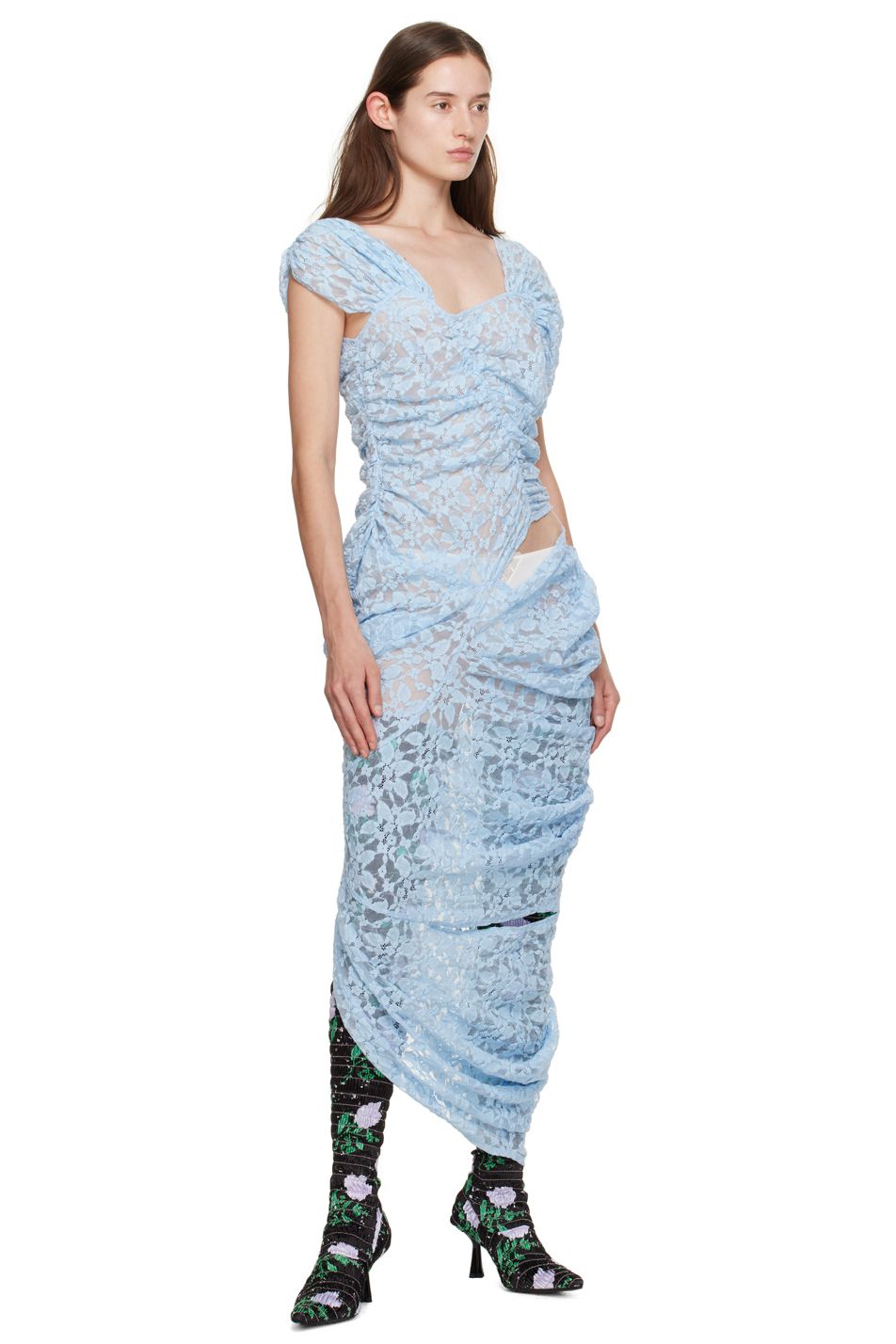 Model Ruby Evers wears a long blue lace gown and floral boots by designer Yuhan Wang for SSENSE.