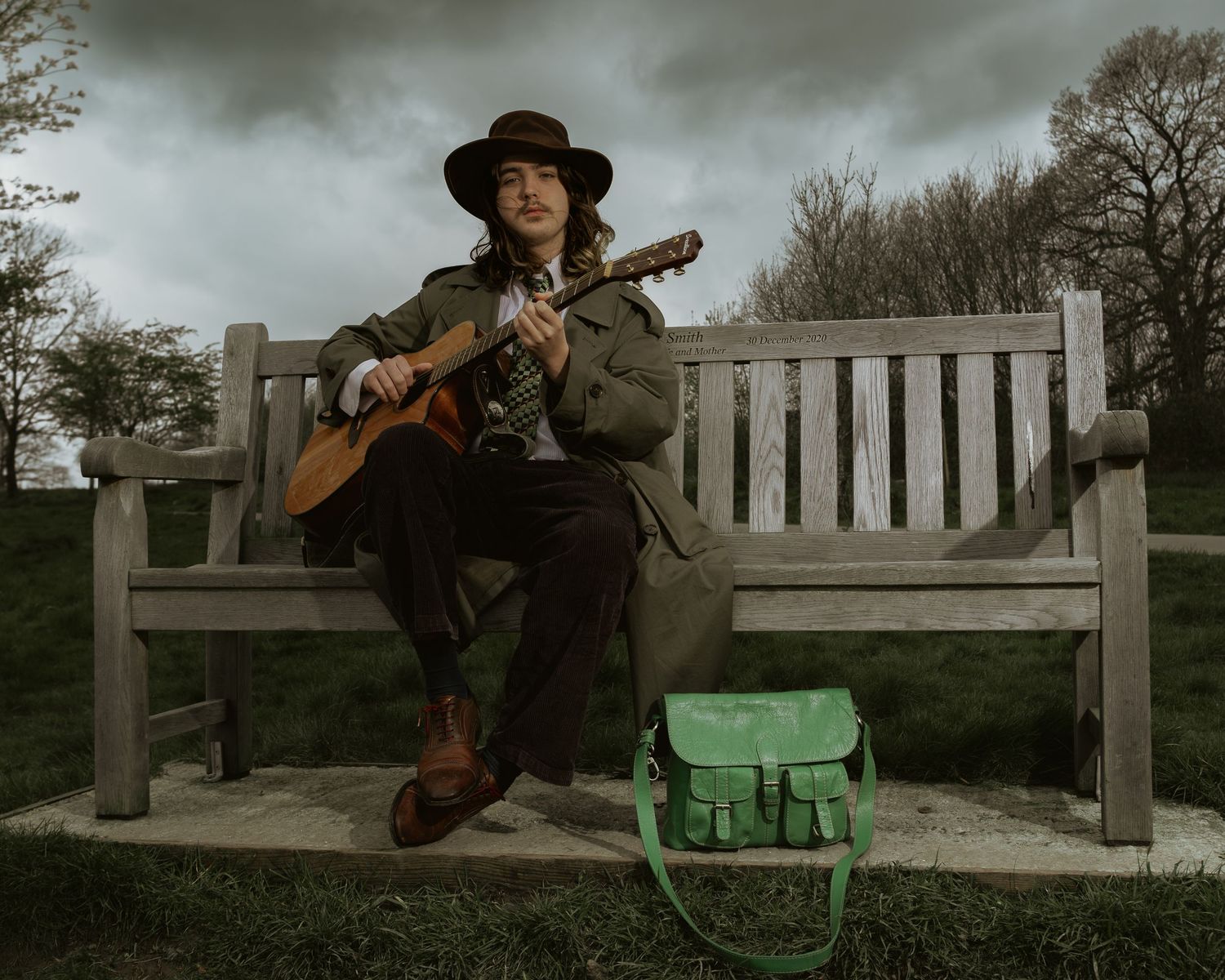 Cinematic portrait of a musician playing guitar outdoors in Farnham