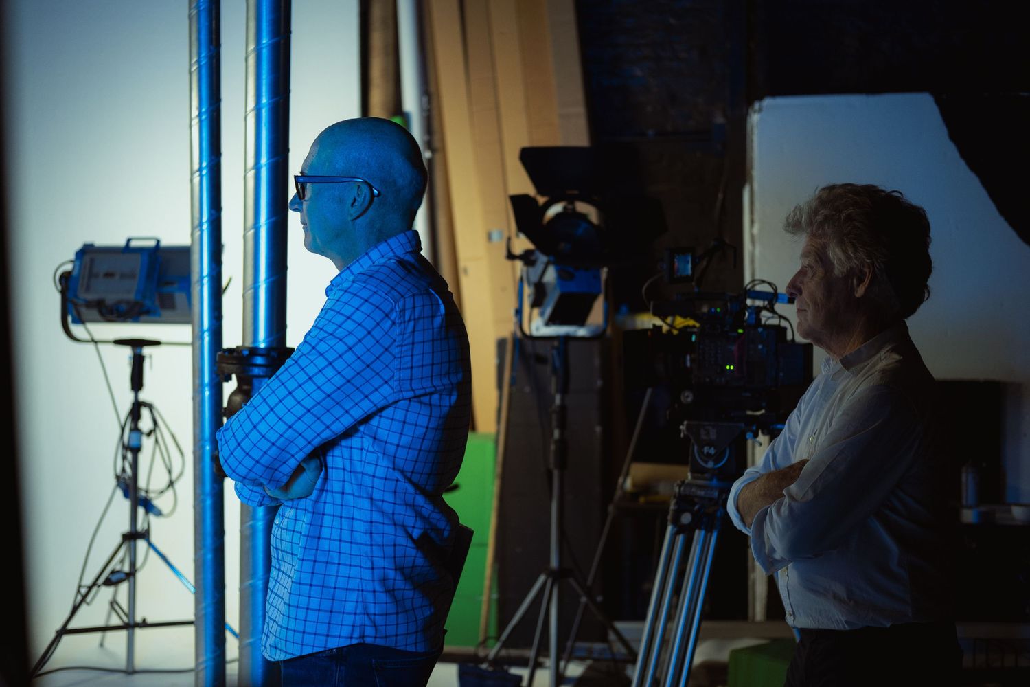 Behind-the-scenes photograph of a film crew working with professional camera and lighting equipment during a production.
