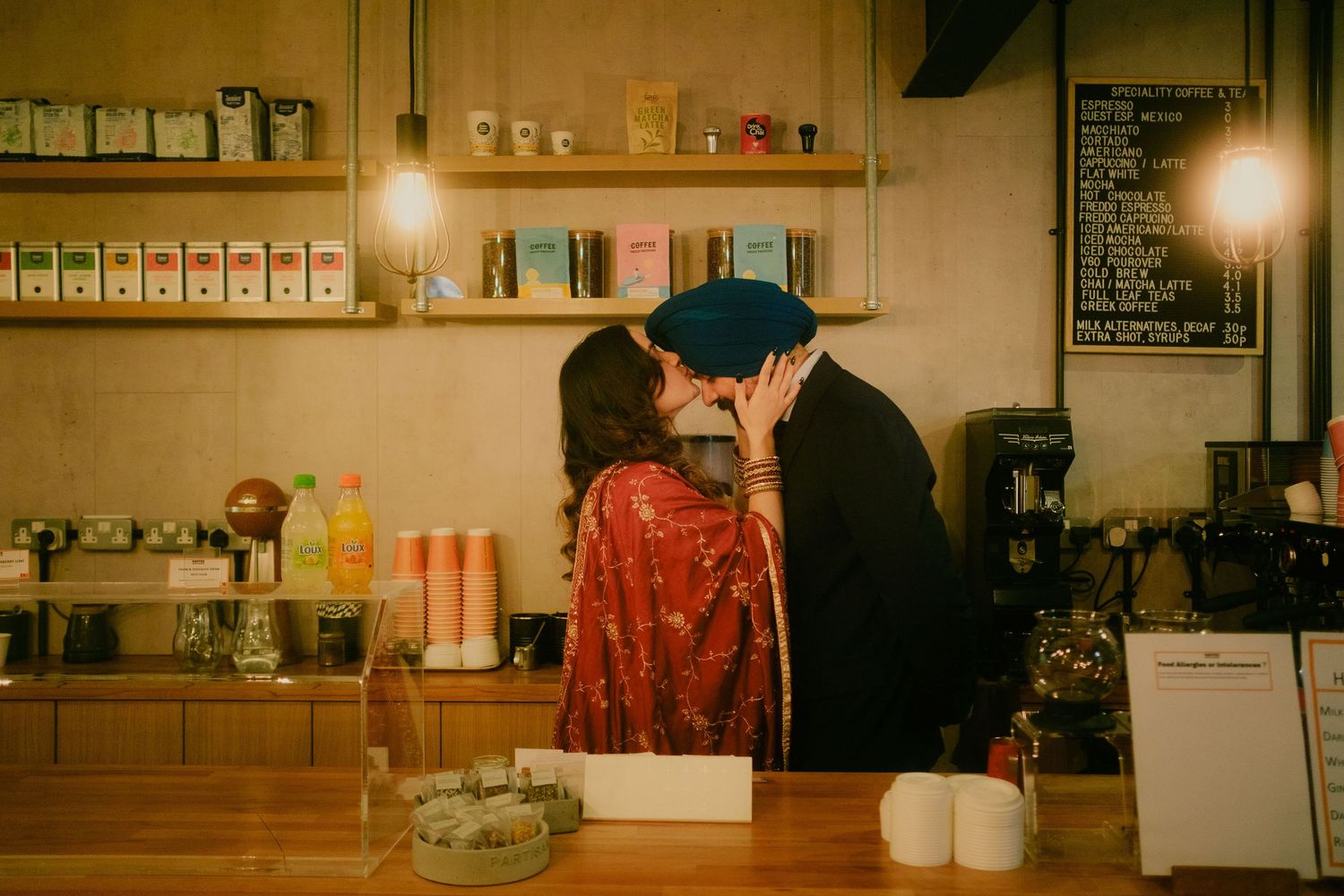 Candid portrait of a couple sharing a quiet moment together inside a cafe.