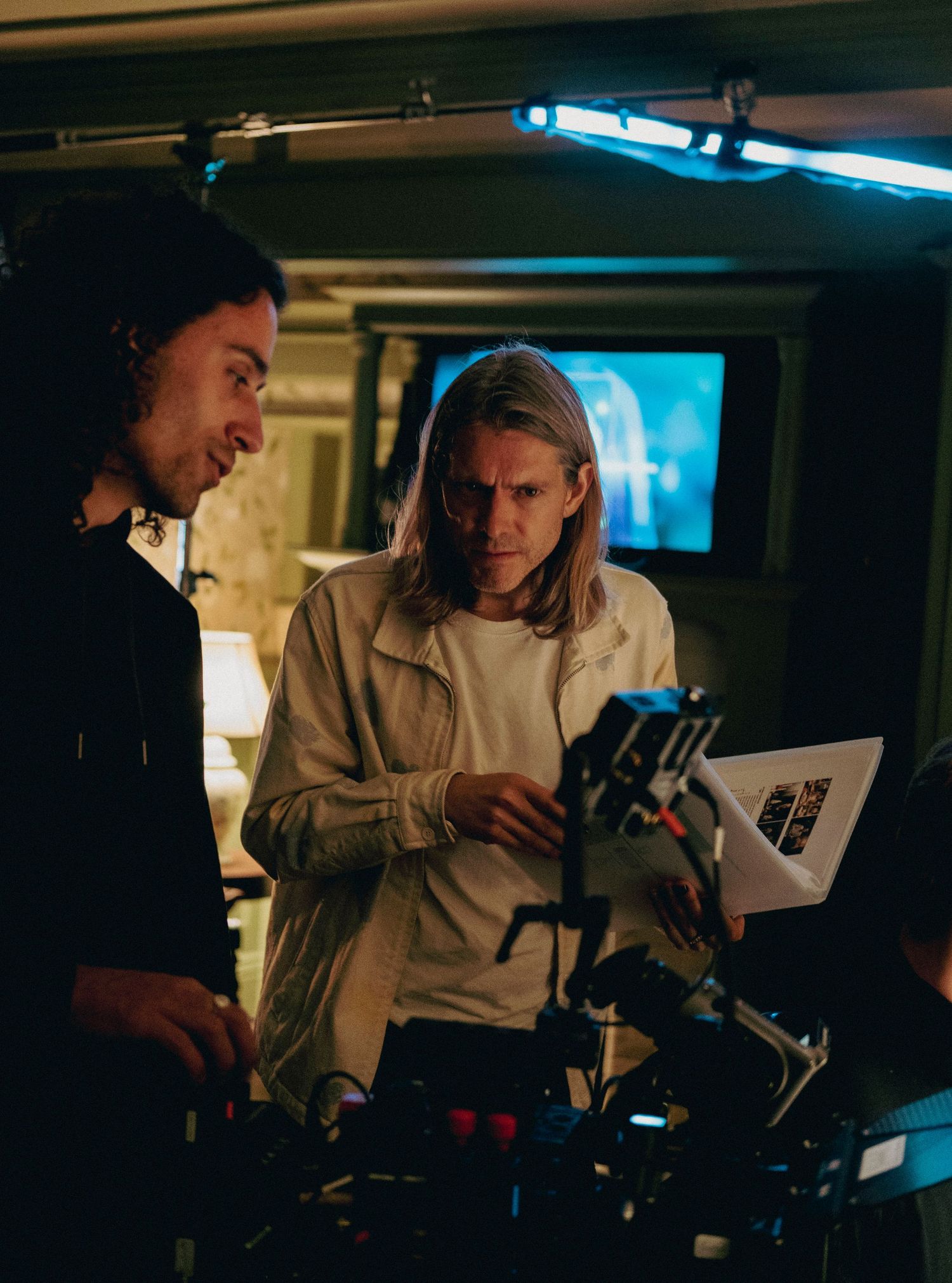 Film crew reviewing a camera monitor together during a professional film production.