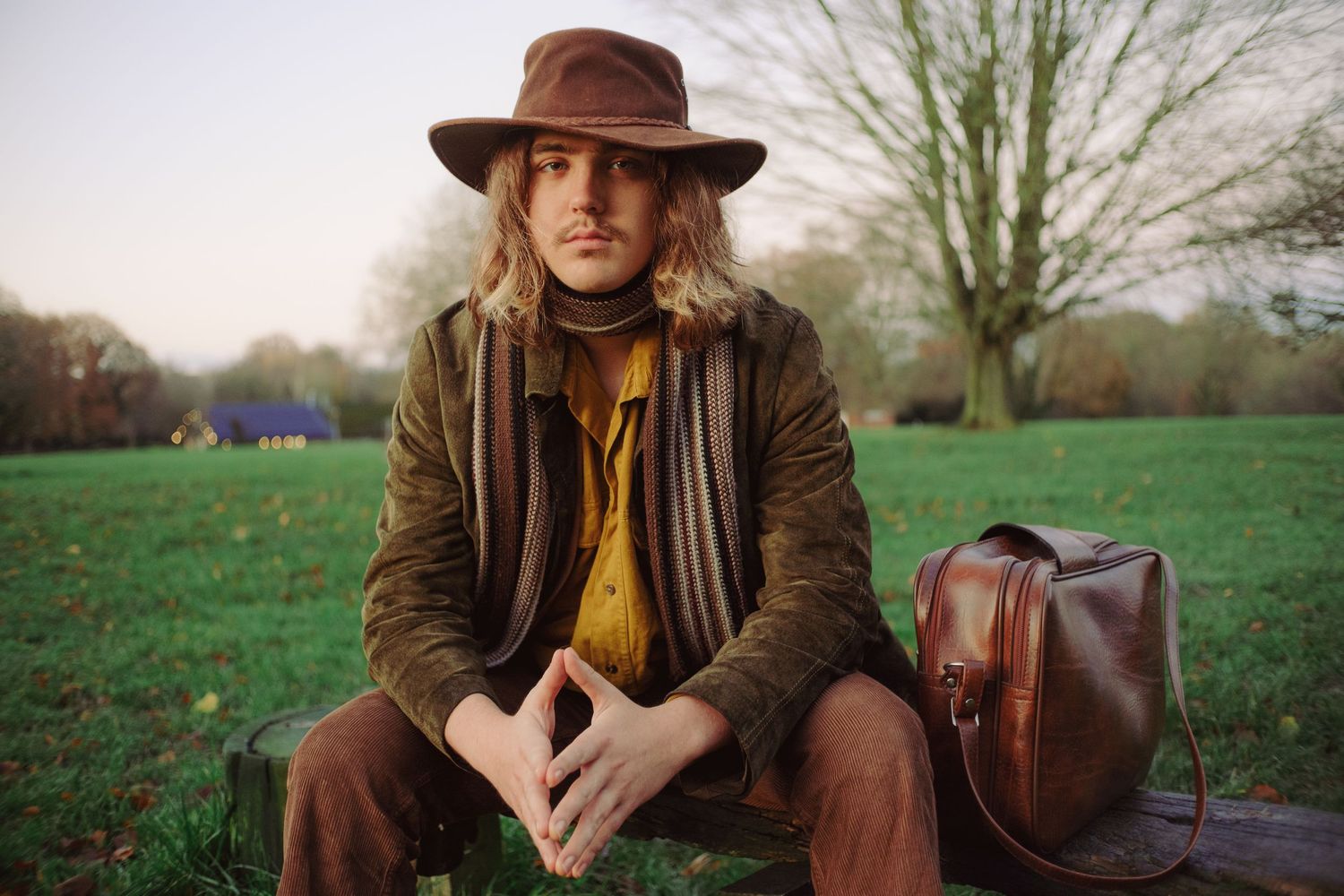 Cinematic portrait of a man wearing a vintage hat and clothing outdoors