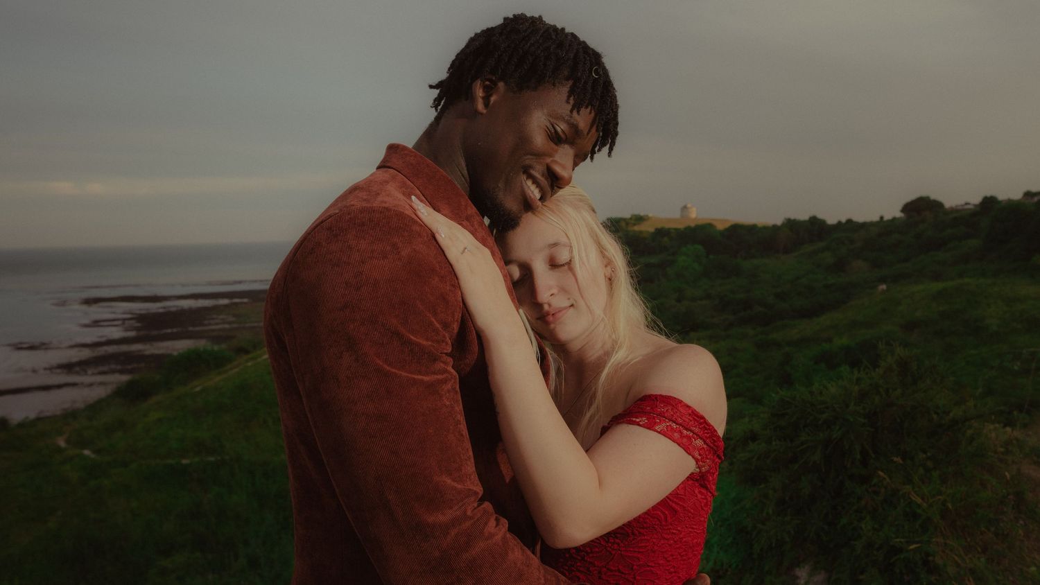 Couple embracing outdoors at sunset during a romantic couples photoshoot