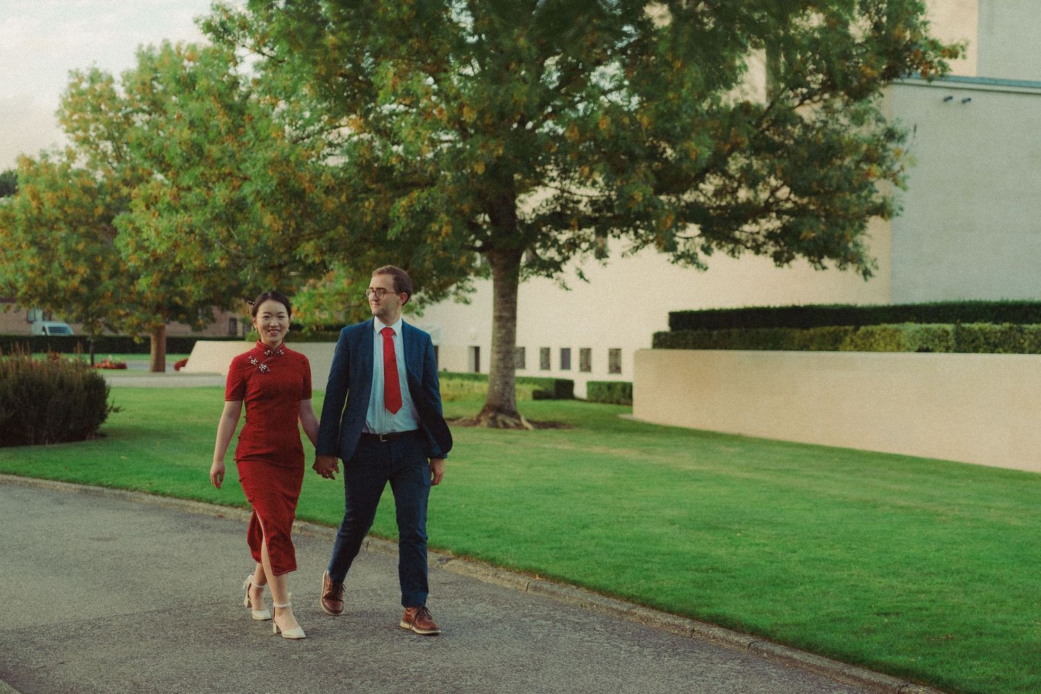 Cinematic pre-wedding photograph of a couple walking together outdoors, capturing a relaxed and natural moment.