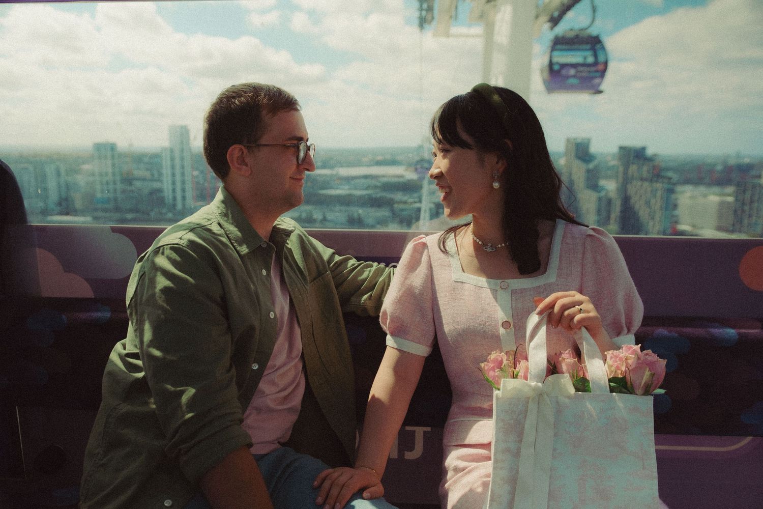Couple having a romantic time inside Cable cars in London.