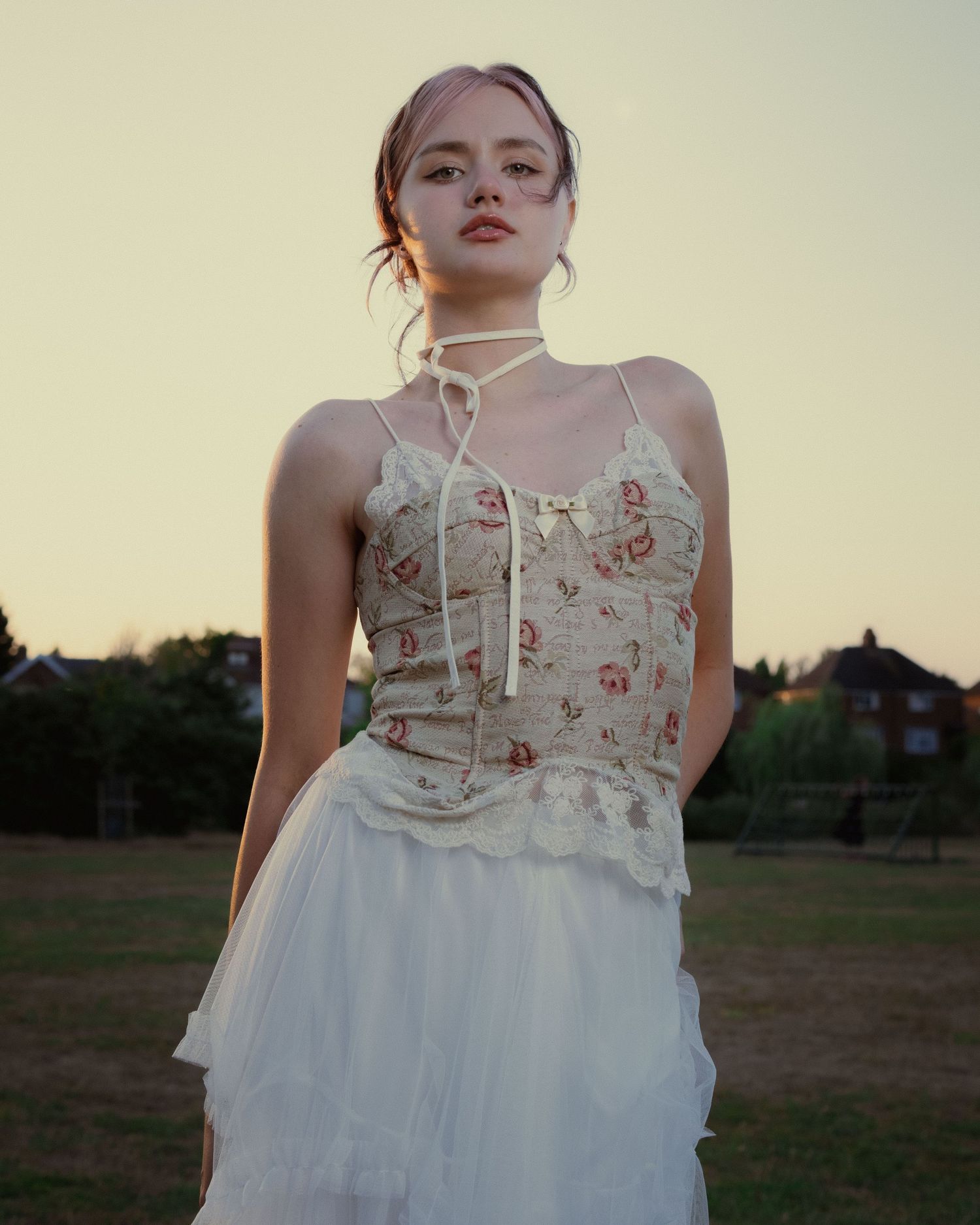 Cinematic portrait of a woman wearing a vintage-inspired dress outdoors