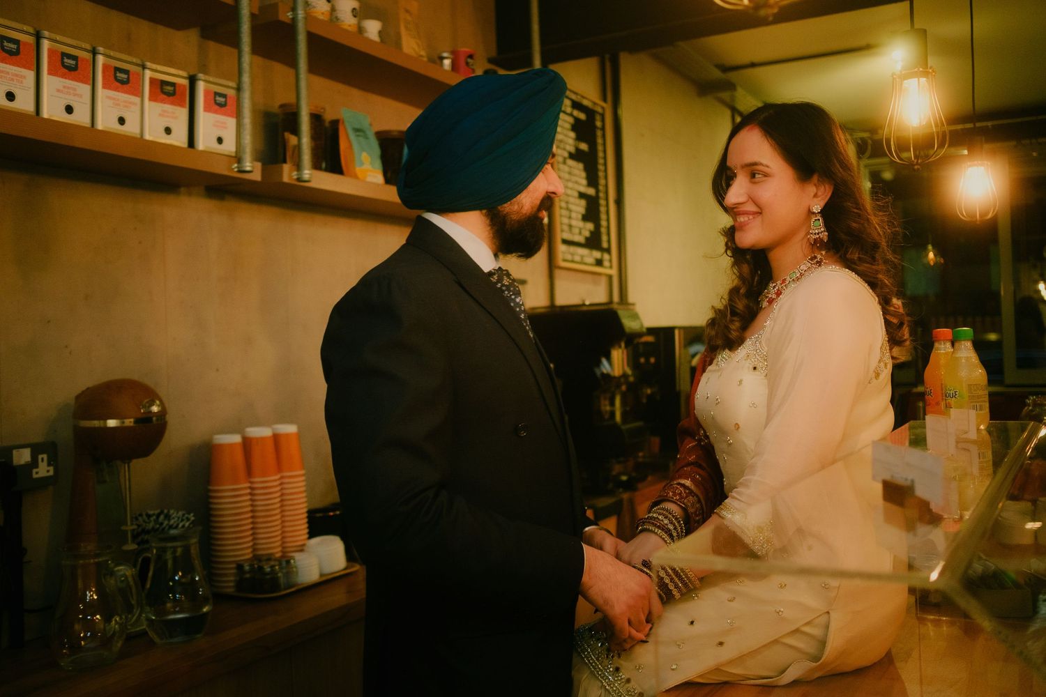 Intimate couples portrait of two people sharing a moment together inside a cosy café.