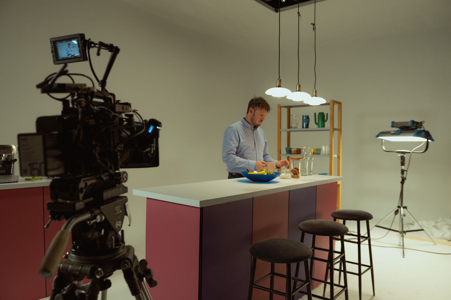 Behind-the-scenes photograph of a commercial food production with a professional cinema camera and lighting setup.