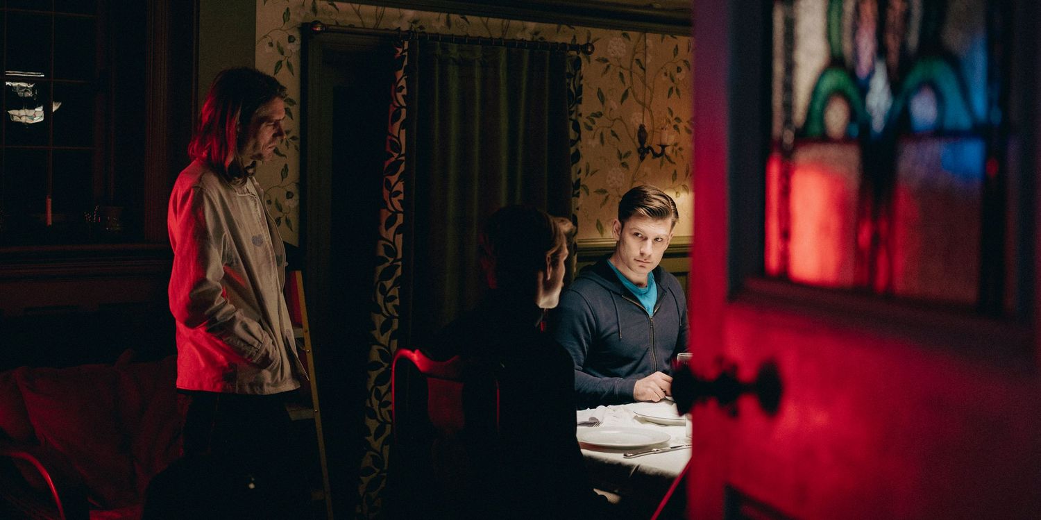 Cinematic behind-the-scenes photograph of actors and crew working together on a dramatic film scene.