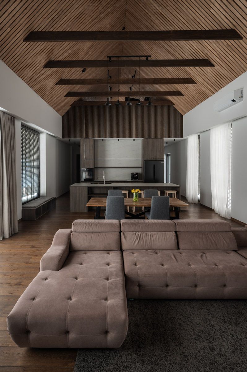 Modern kitchen and living room with warm wood finishes