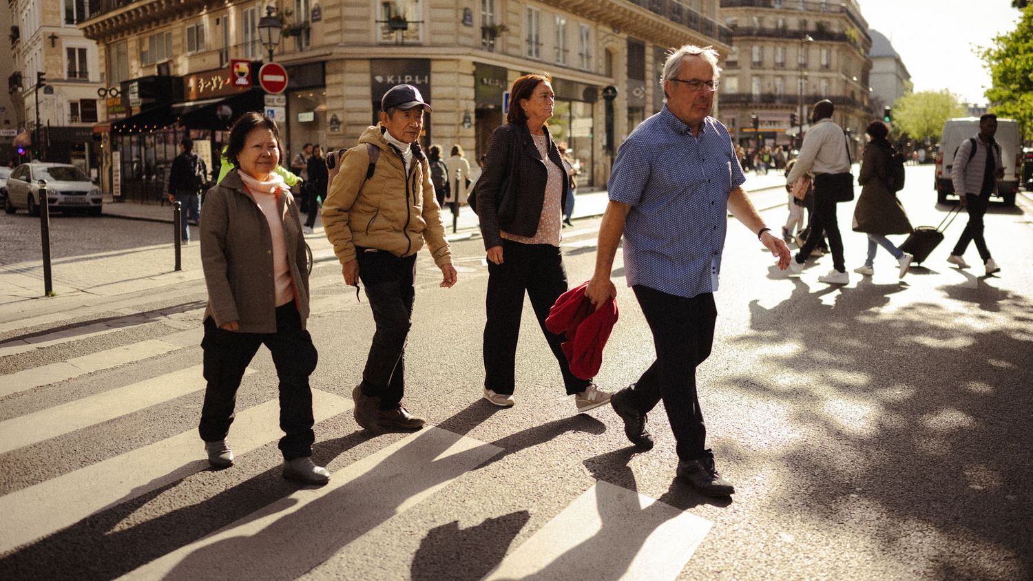 People walking through a Paris street captured in a candid photograph