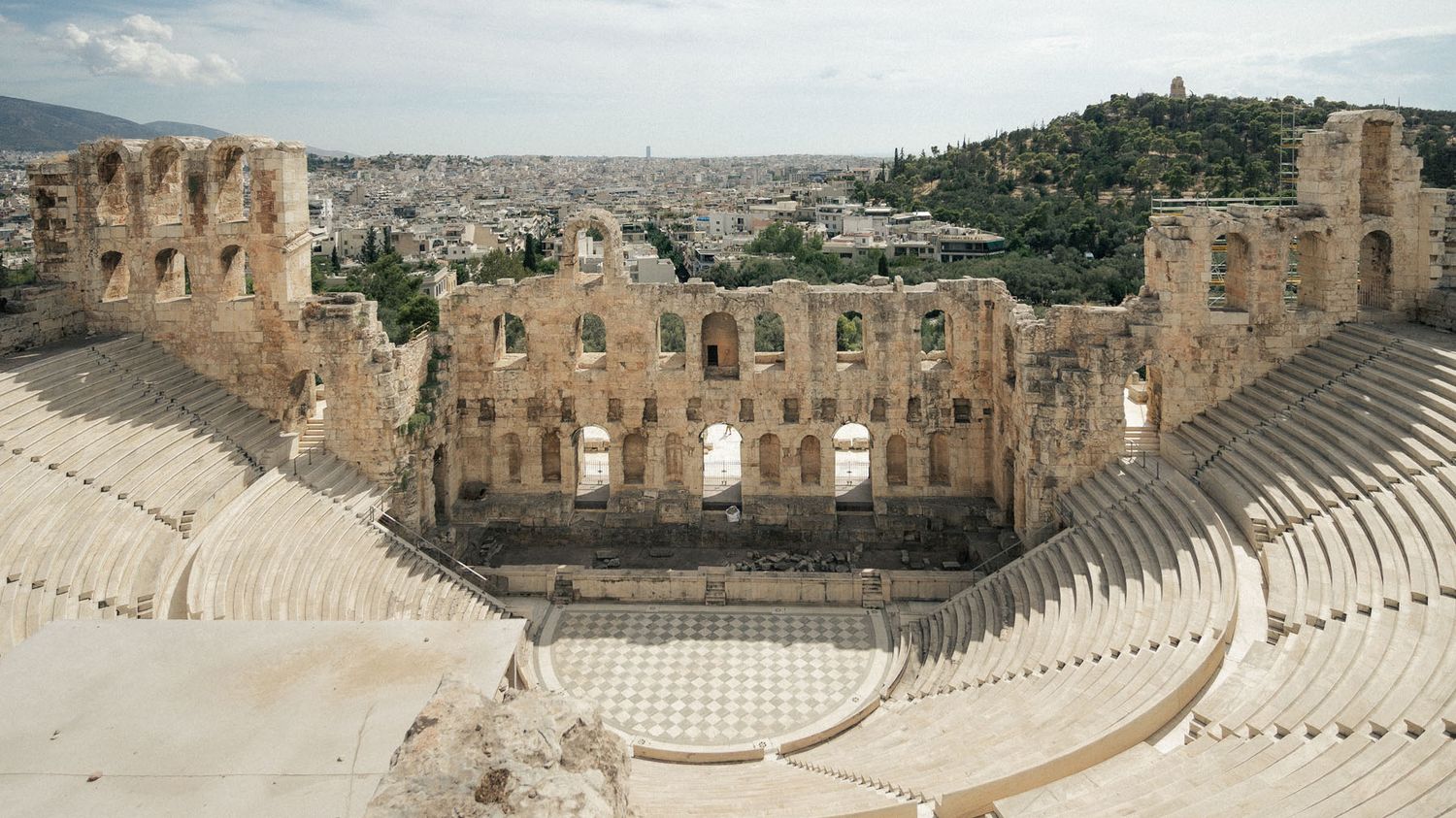 Ancient stone theatre in Athens Greece with historic marble seating