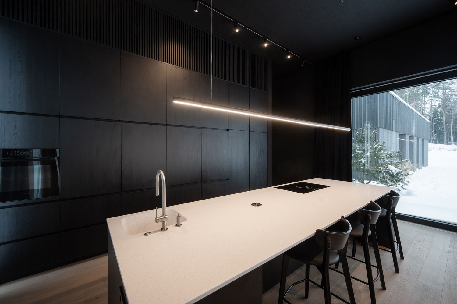 Modern kitchen with white island and dark wood cabinetry