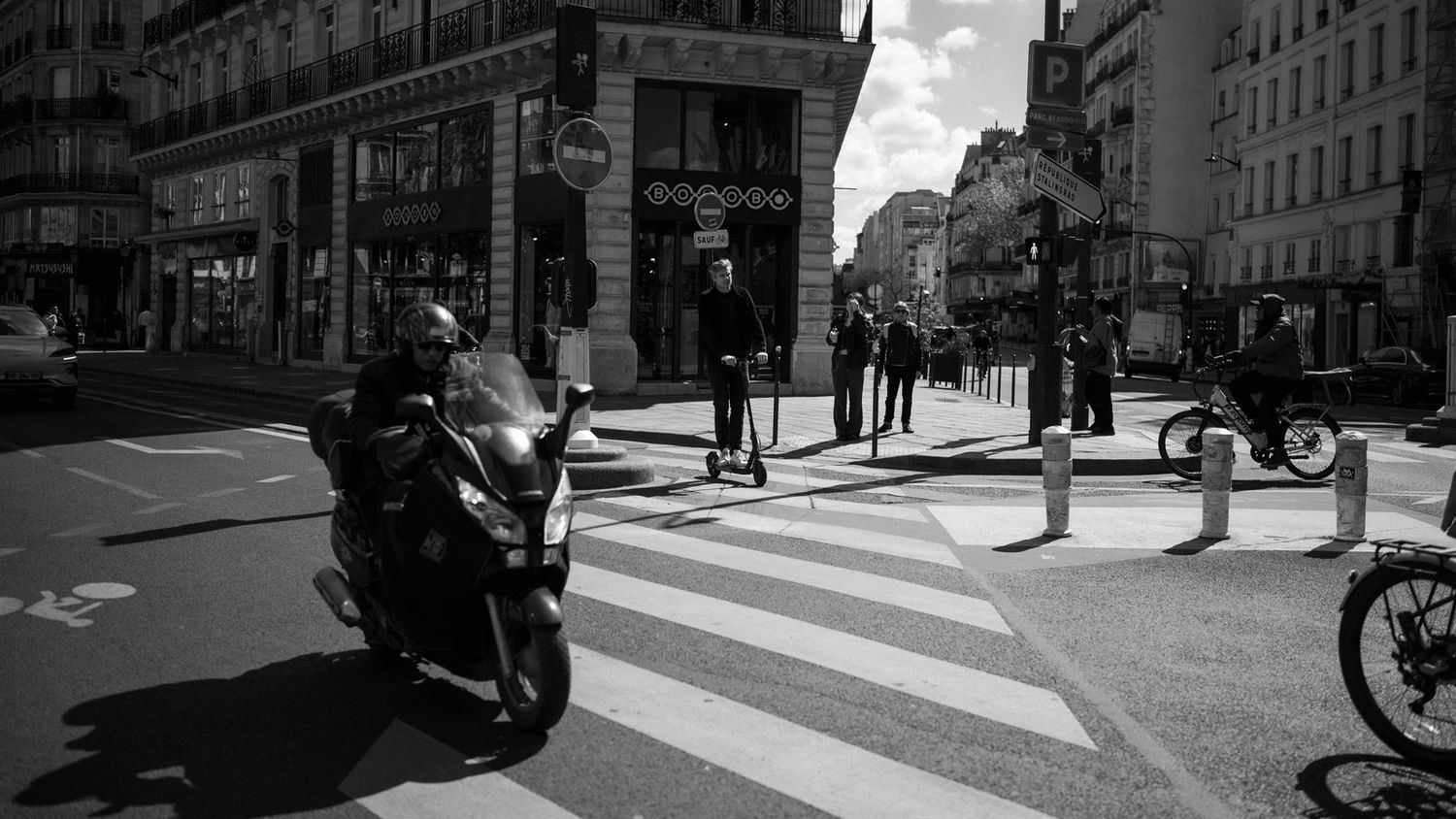 Paris street photography with historic buildings and a busy city intersection