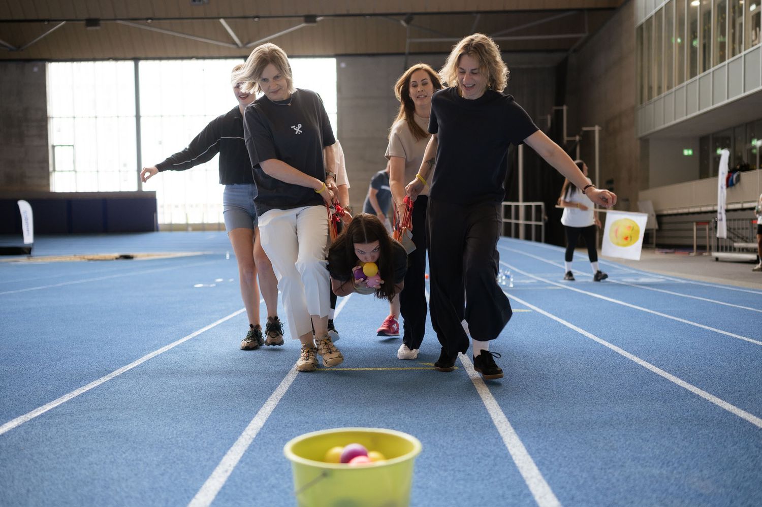 Team members completing a physical challenge during the summer event