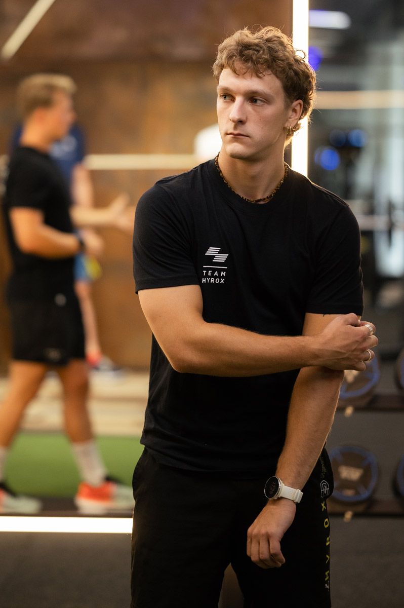 Athletes competing in a HYROX-style fitness challenge
