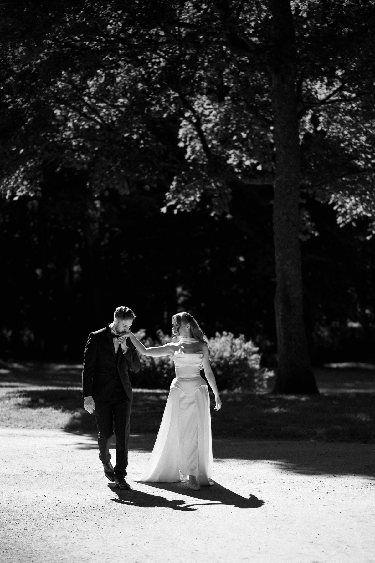 Bride and groom walking through Birutė’s Park
