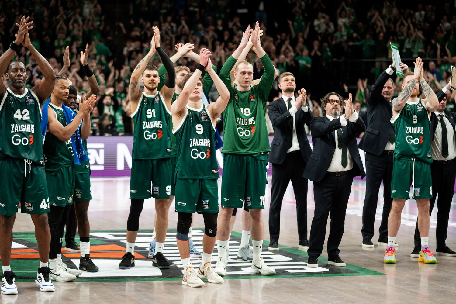 Žalgiris players and coaches on the basketball court