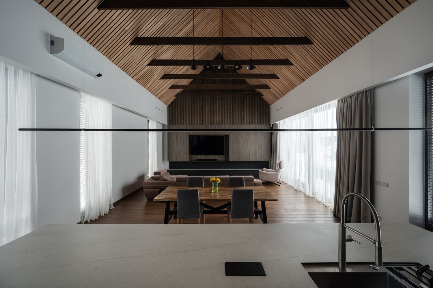 Contemporary living room with a dramatic timber ceiling