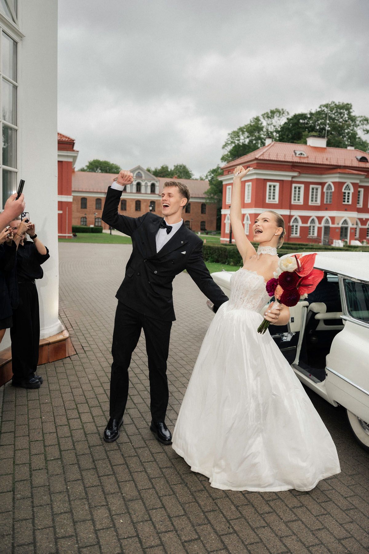 Bride and groom celebrating with wedding guests in Kaunas