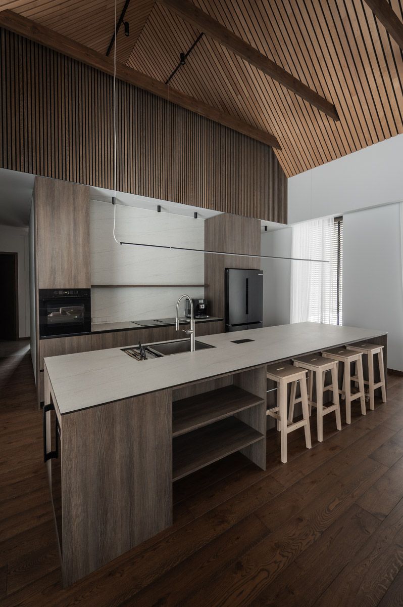 Modern kitchen and dining area with a timber ceiling
