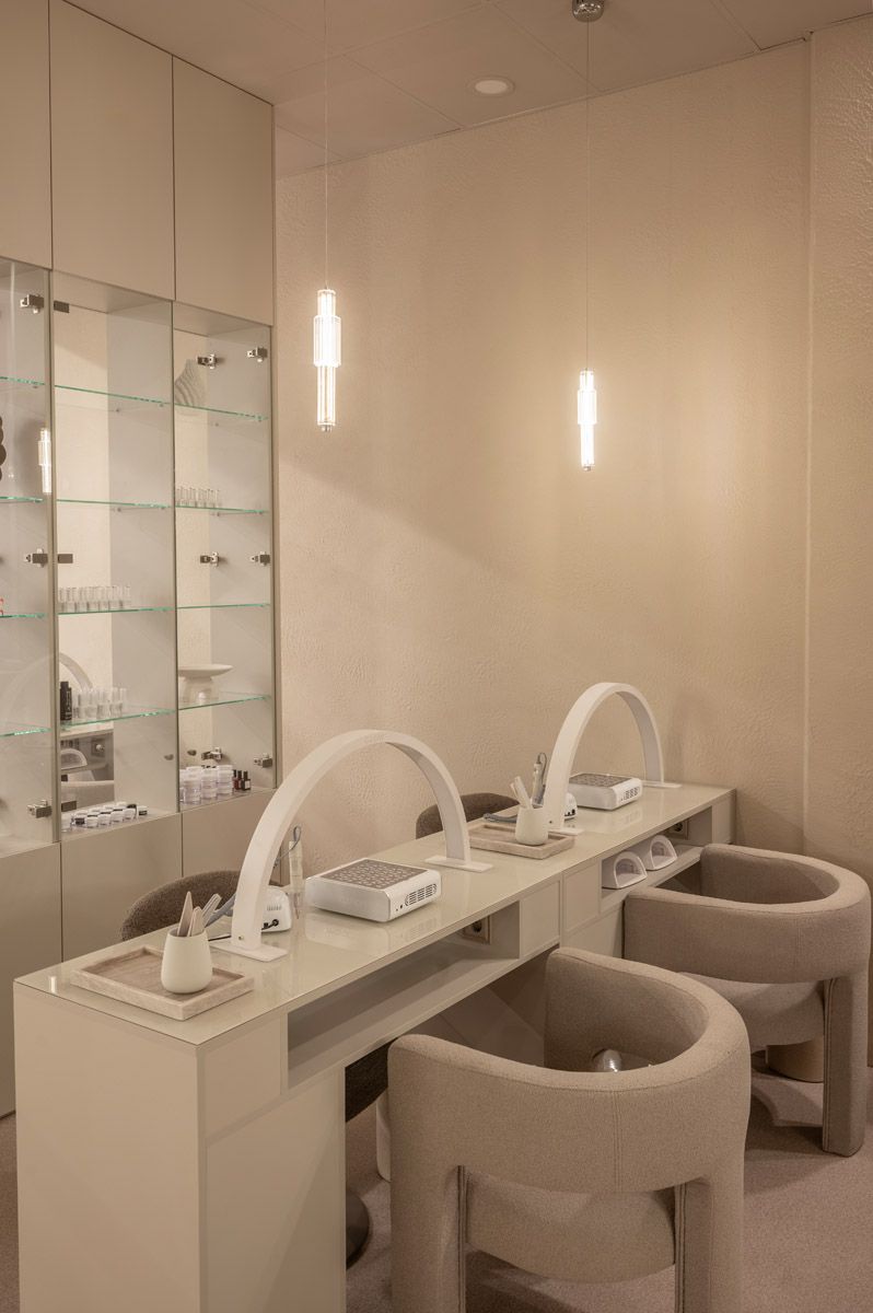 Contemporary beauty salon interior with mirrors and treatment stations