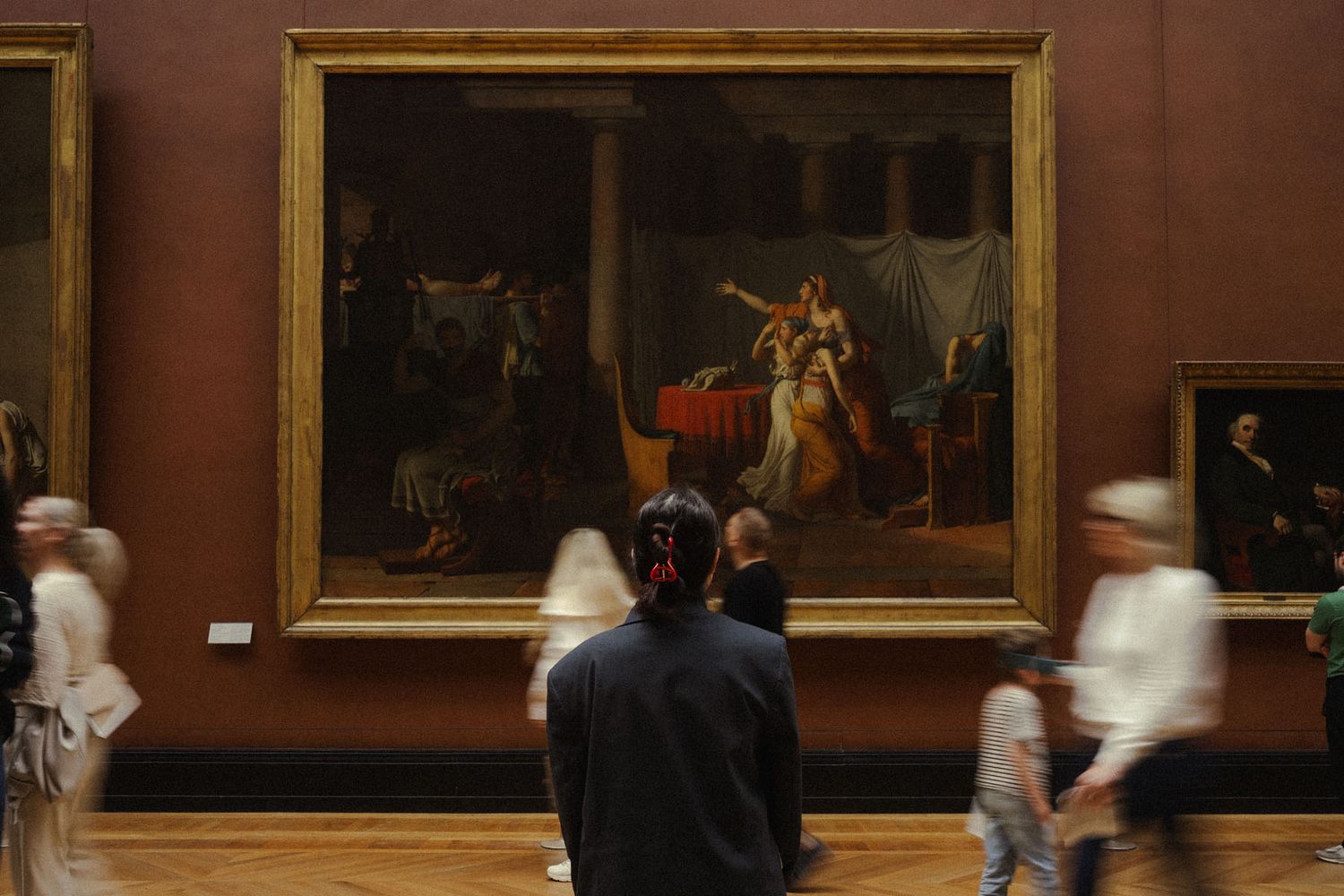 Interior of a Paris museum with visitors and historic architecture