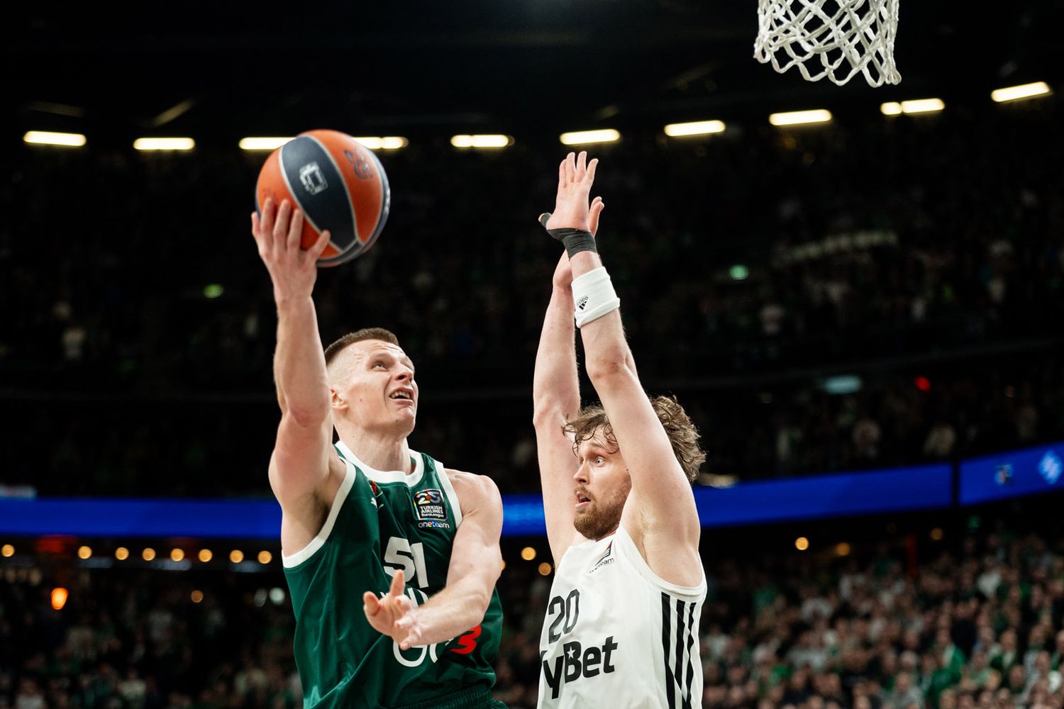 Basketball players competing during the Žalgiris vs Paris EuroLeague game