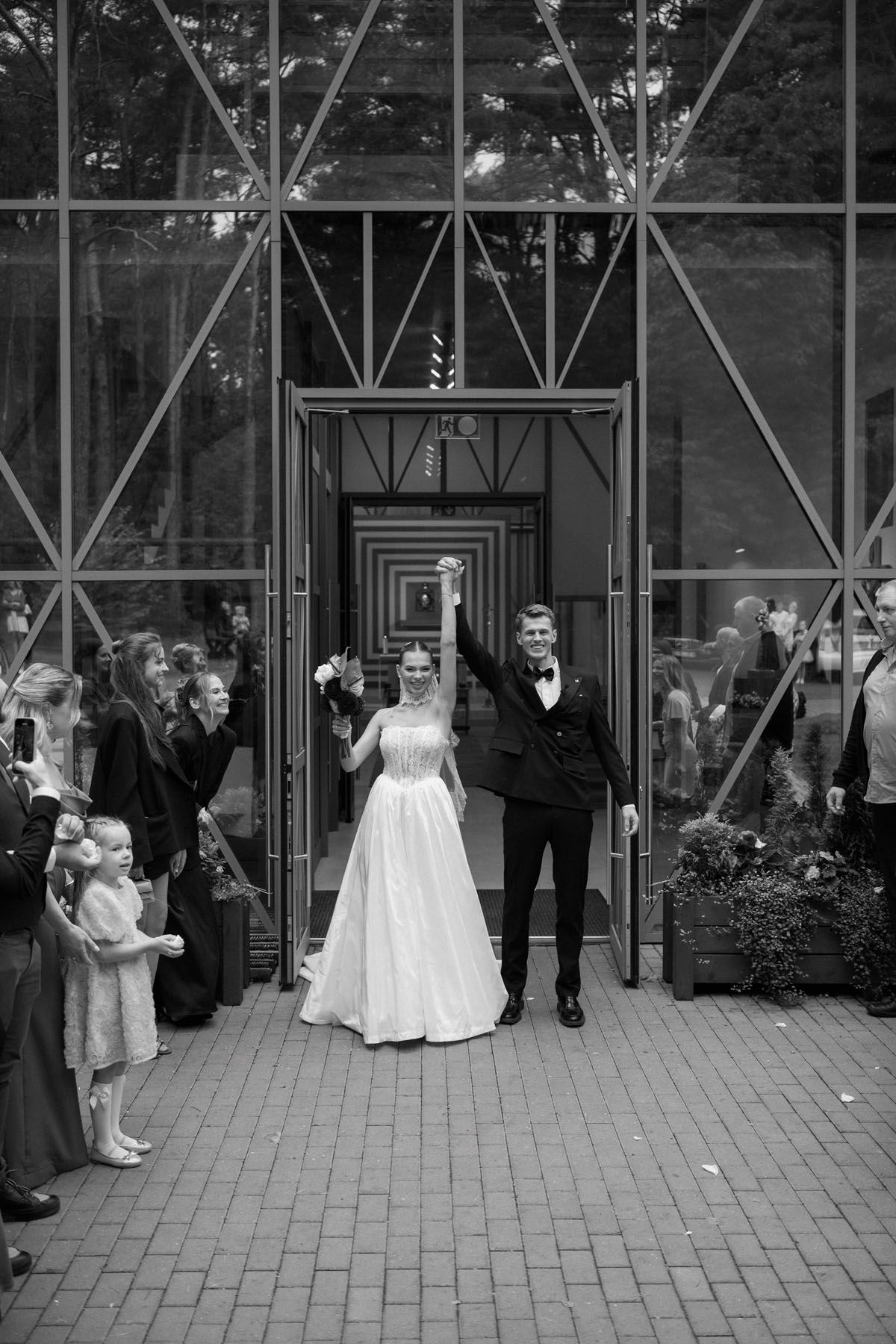 Bride and groom walking together outside their wedding ceremony in Kaunas