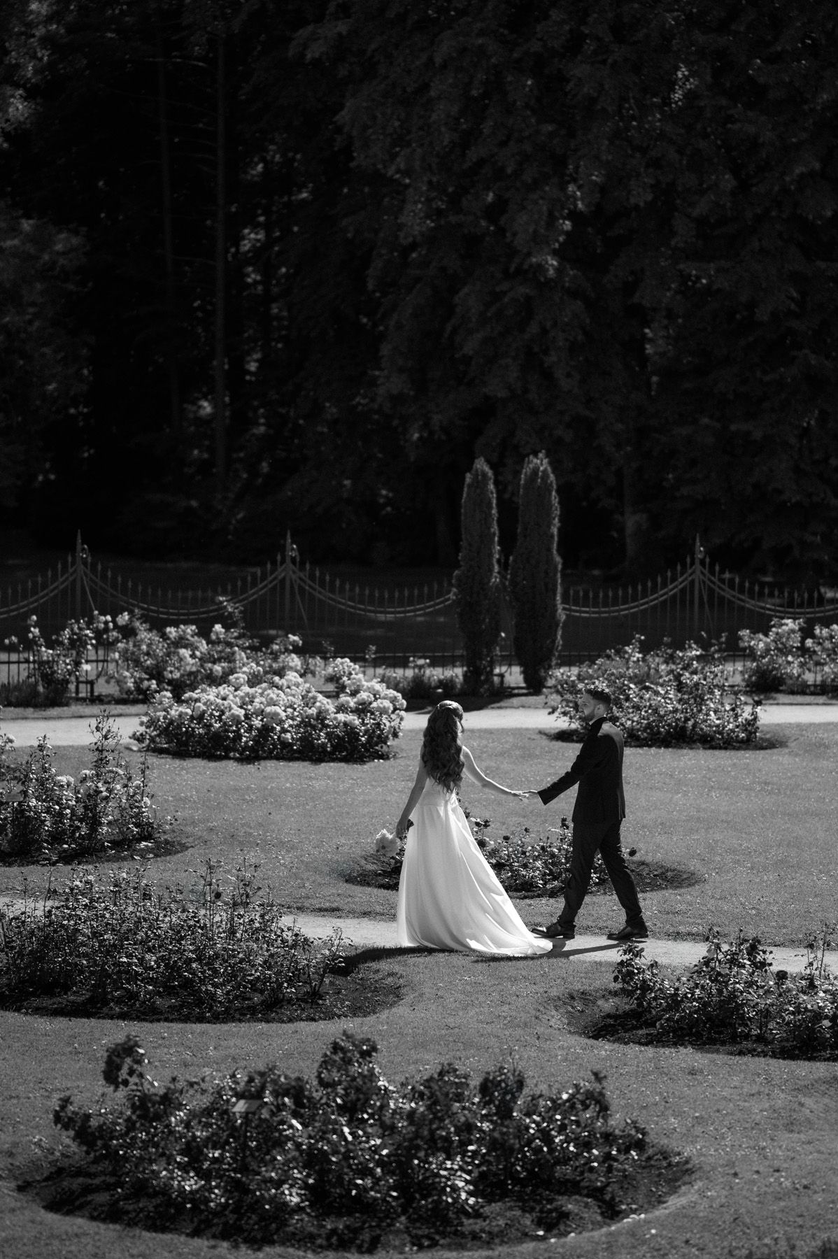 Bride and groom walking through Birutė’s Park