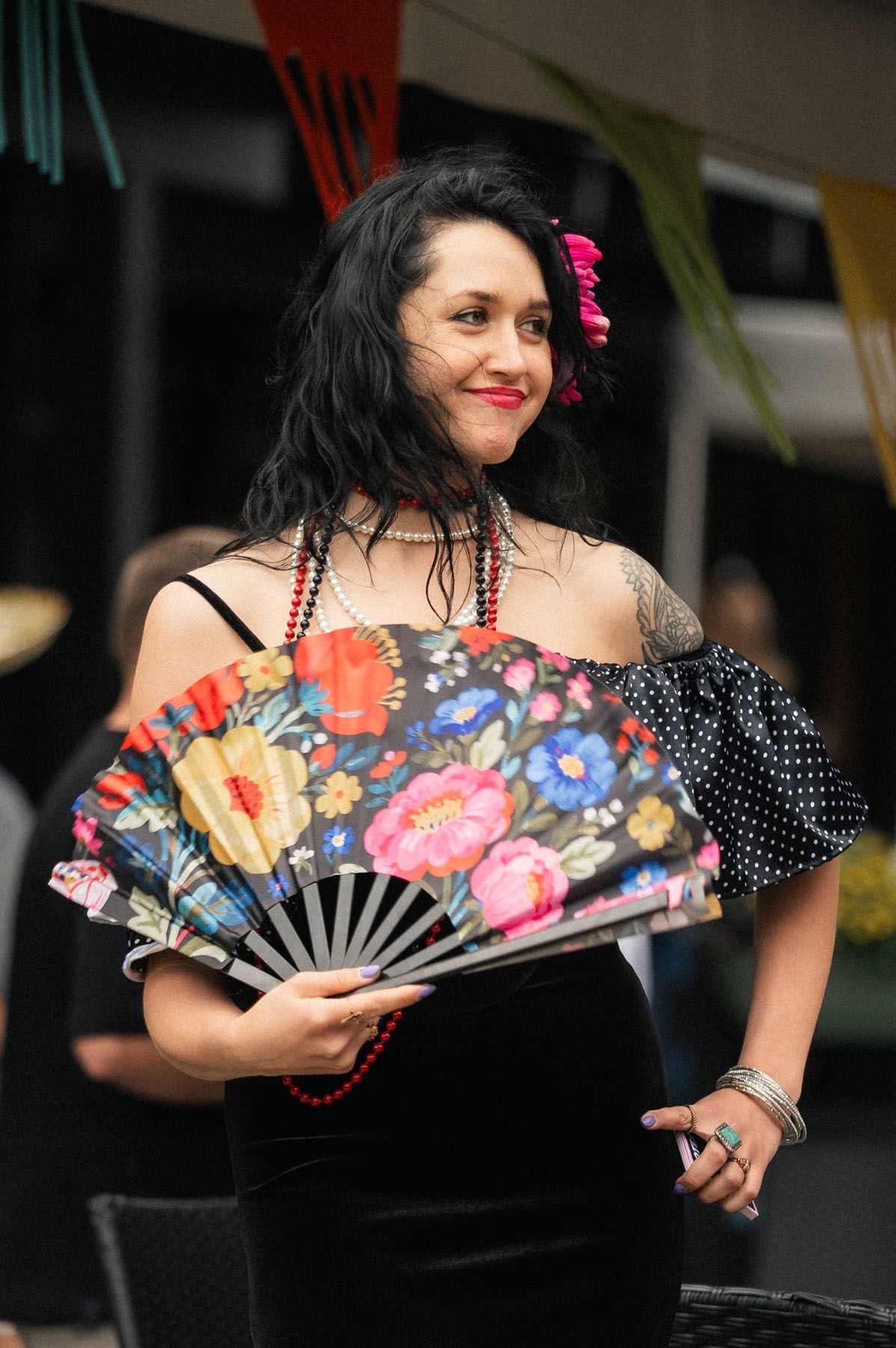 Woman posing with a decorative Mexican fan